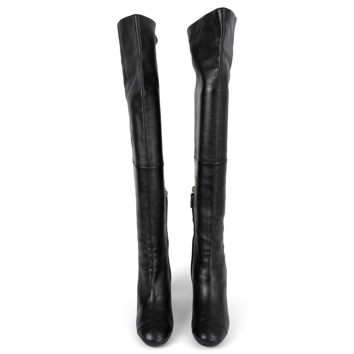 100% authentic Chanel CC over-knee boots in smooth soft lambskin. The design features the calssic cap toe, inside zipper and CC logo stitching on the inner shaft. Have been worn and show some wear to the tips and one zipper pull is missing. Overall