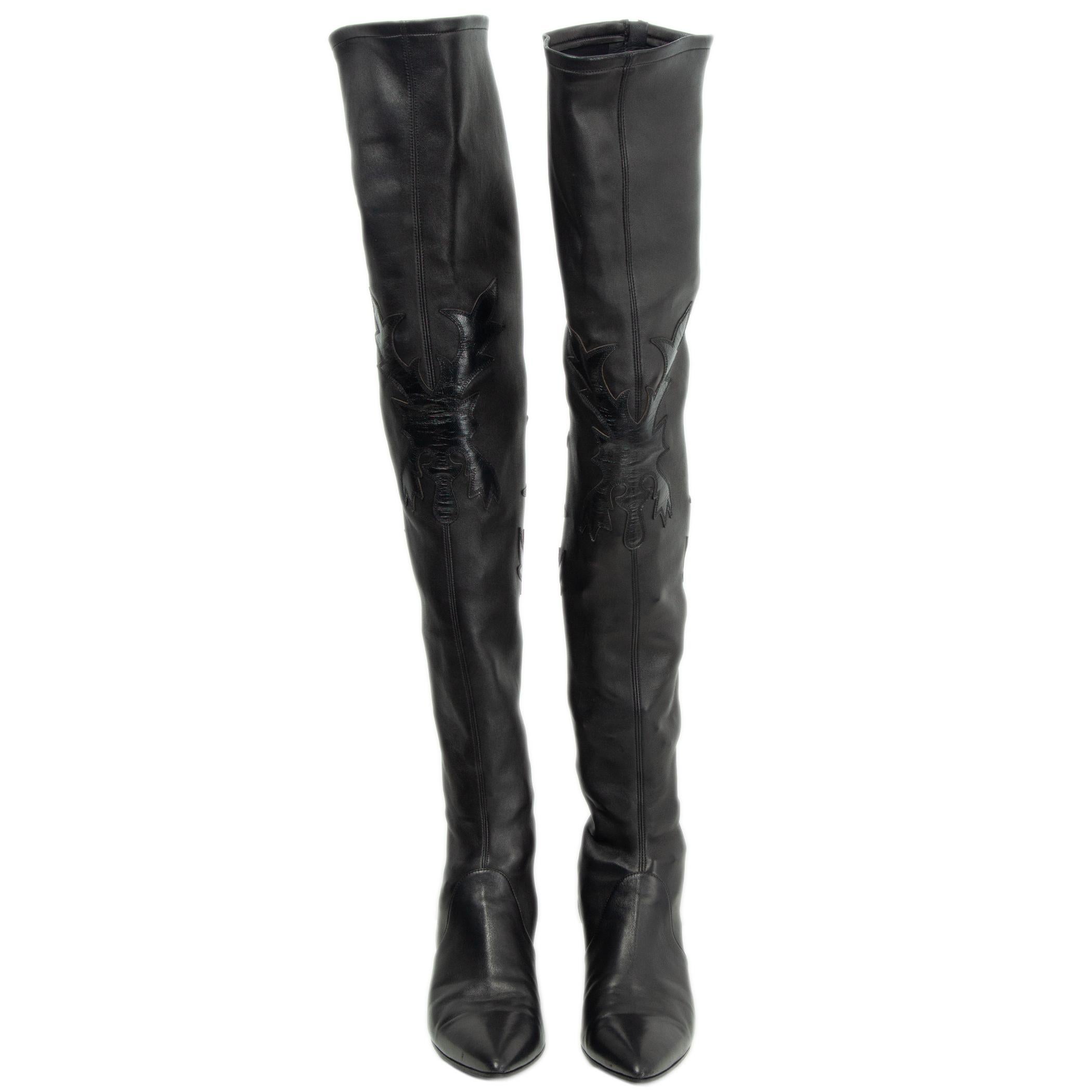 100% authentic Chanel thigh-high over-knee boots in black smooth lambskin leather with western appliques. Featuring a pointed-toe and block heel. Open with a zipper on the back of the shaft. Have been worn and are in excellent condition. Come with