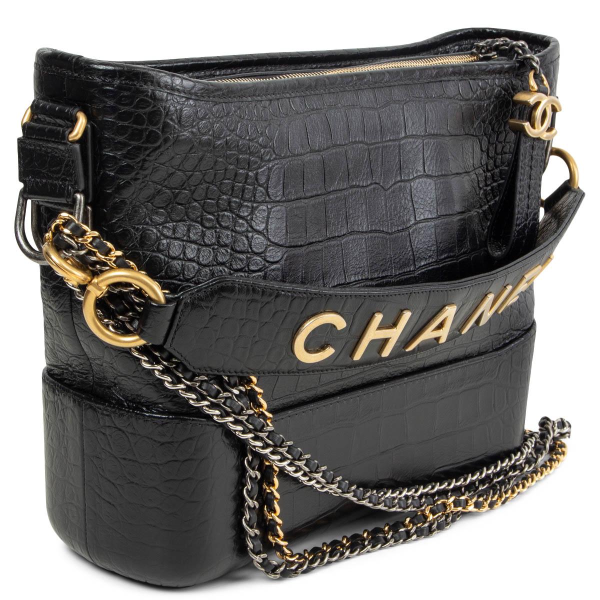 100% authentic Chanel Gabrielle Medium hobo bag in black croco embossed calfskin. Double chain shoulder-strap in gold-tone, silver-tone & ruthenium-finish metal. Opens with a CC zipper on top and is lined in black grosgrain fabric with one zipper