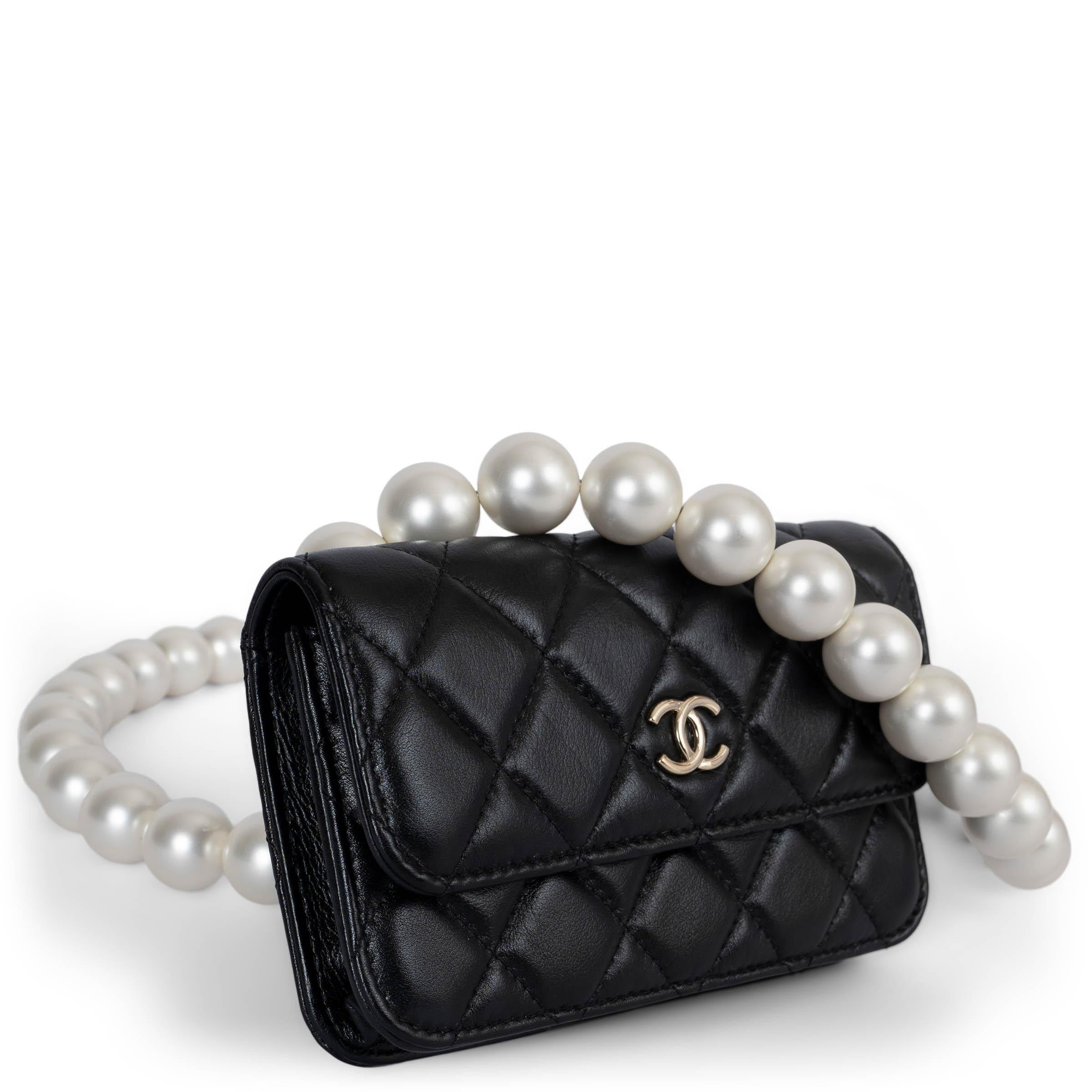 This 100% authentic Chanel Maxi Pearls clutch is crafted from black quilted calfskin leather, featuring a chic faux pearl strap and elegant silver-tone hardware with the signature CC detail on the front. It closes with a magnetic snap under the flap