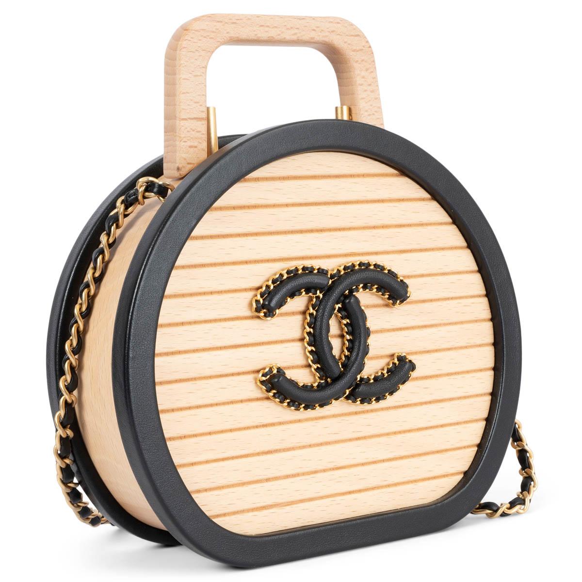 100% authentic Chanel Small Vanity bag in beige beechwood with black leather trims and antique gold-tone hardware. Rare limited edition. Opens with a logo clasp closure and is lined in black quilted calfskin and wood with one quilted classic flap