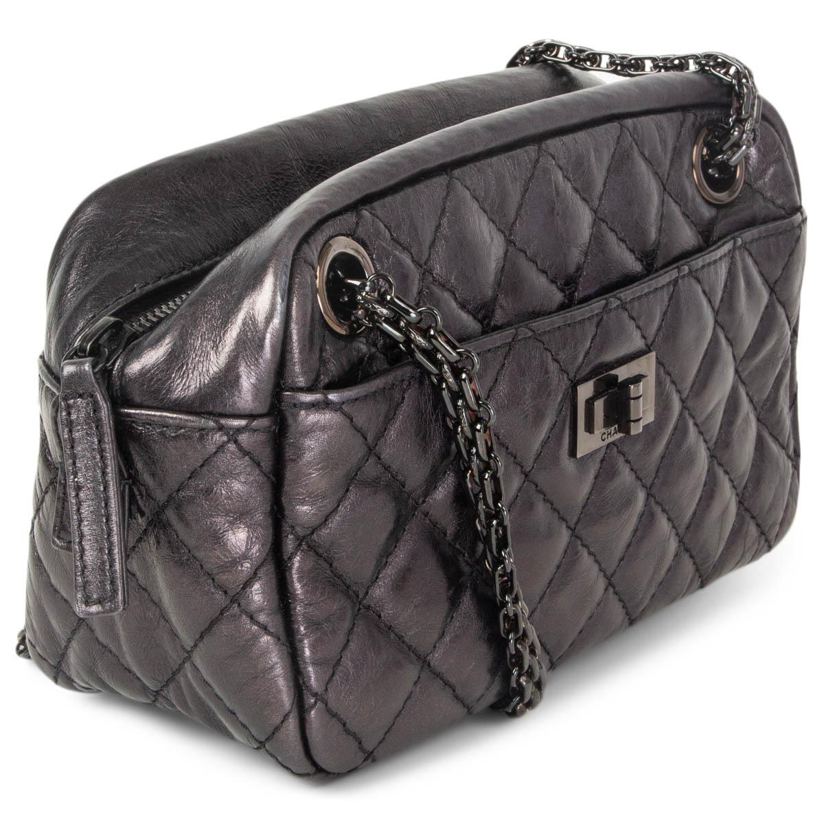 100% authentic Chanel '2.55 Reissue Camera' mini shoulder bag in black quilted aged calfskin leather. Front pocket with turn-lock and open back pocket. Closes with a zipper on top. Lined in leather with an open pocket against the back. Has been