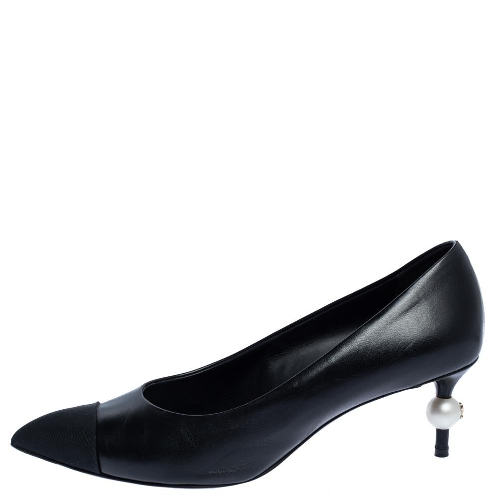 The perfect blend of luxury and elegance, these pumps from Chanel come crafted from black leather and canvas. Designed with pointed toes and durable soles, the pumps flaunt the perfect finishing touch of faux pearls on the heels.

Includes:Original