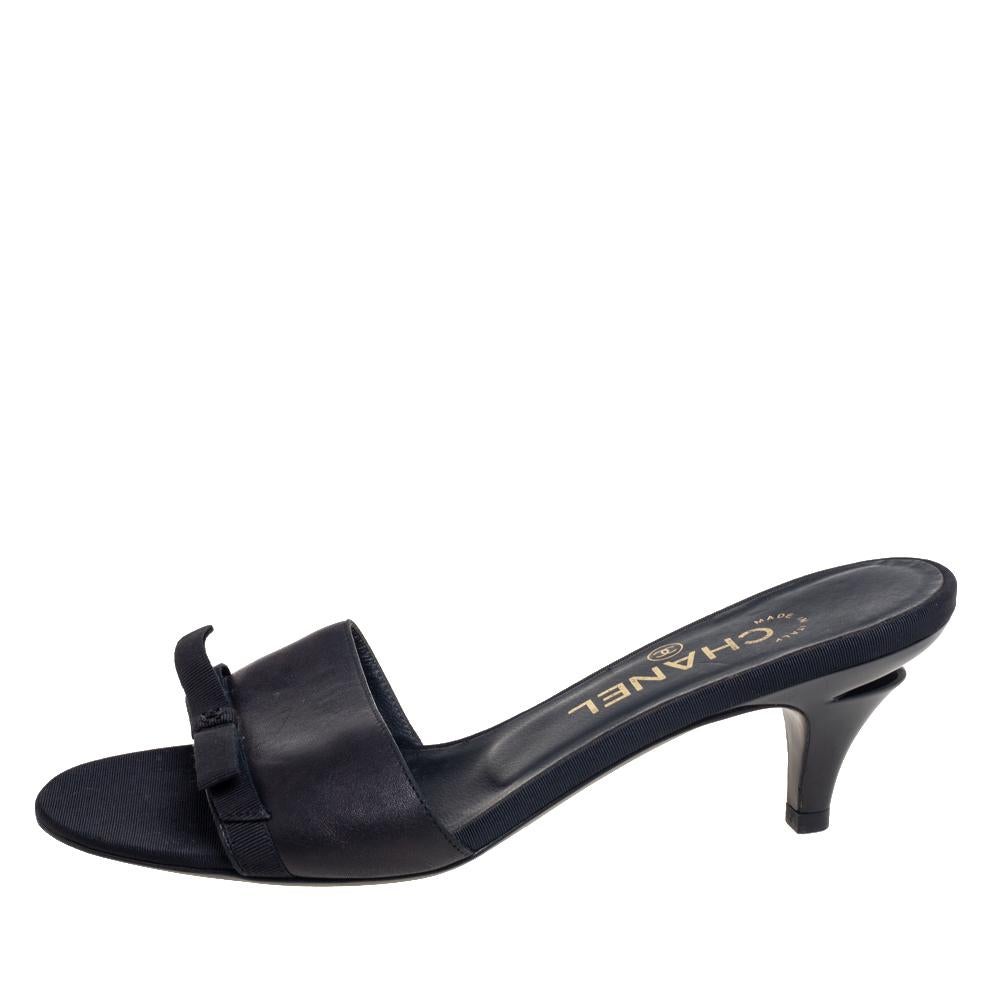 Step out in luxurious style by wearing these Chanel sandals that have been crafted from leather and fabric. The black slides are easy to slip into and come with bow details, open-toes, and comfortable insoles.

Includes: Original Dustbag