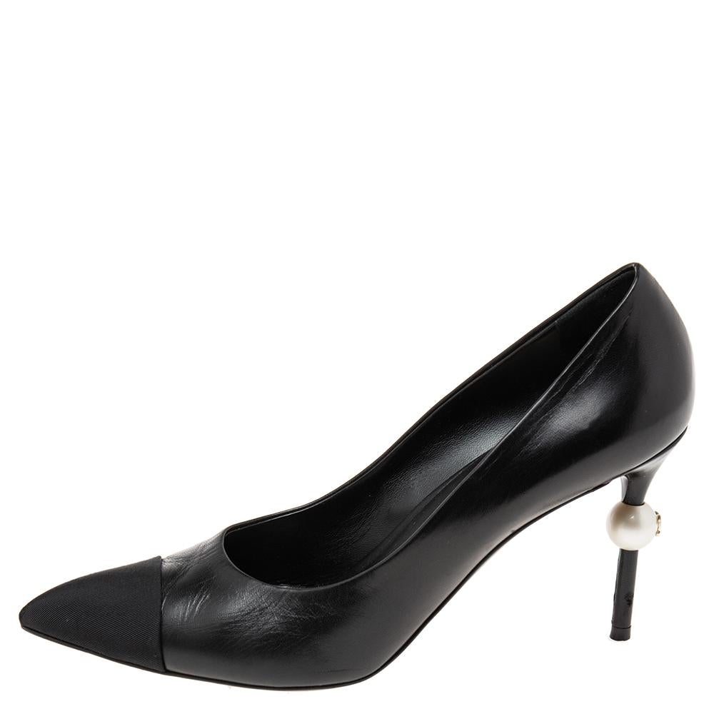 These pumps from the House of Chanel will help you take every step with confidence, luxury, and style! They are crafted using black leather and fabric on the exterior. These pumps showcase pointed toes, a slip-on style, and faux pearl-embellished
