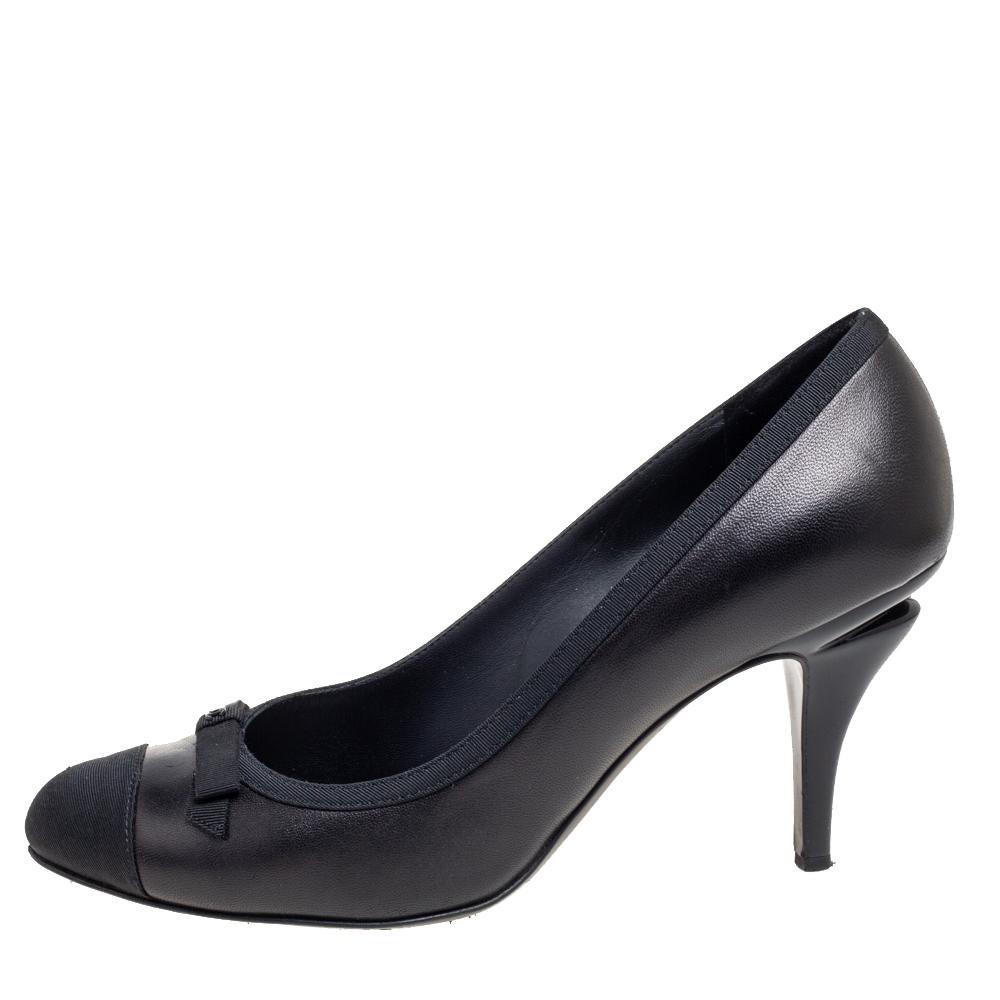 These stylish and timeless pumps come from the iconic house of Chanel. Crafted from black-hued leather, they are absolute must-haves. They are styled with round grosgrain cap-toes and trims, 8.5 cm heels, and CC logo on the bows.

Includes: Original