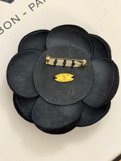 Chanel black leather and red sparkling Camelia brooch