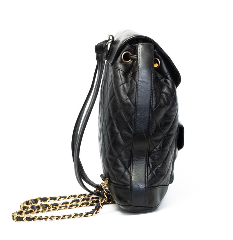 This Vintage Chanel Jumbo Backpack is constructed in lambskin leather with quilted diamond stitching. Featuring an external pocket, a top flap with a gold Chanel CC Mademoiselle turn lock closure and drawstring closure at the top. The adjustable