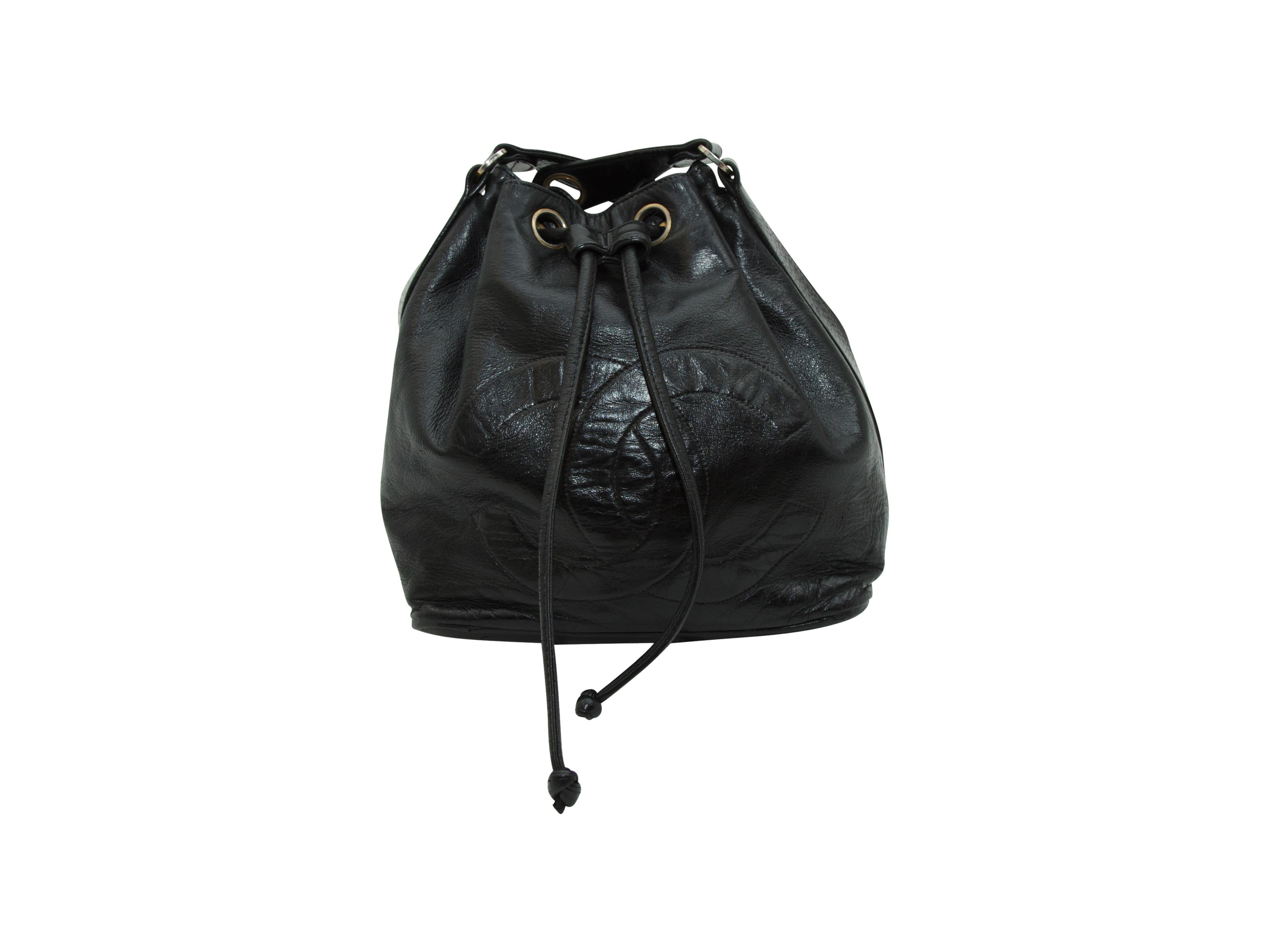 Product details:  Vintage black leather bucket bag by Chanel.  Leather and chain crossbody strap.  Drawstring top closure.  Leather lined interior.  Front logo accent.  Goldtone hardware.  11