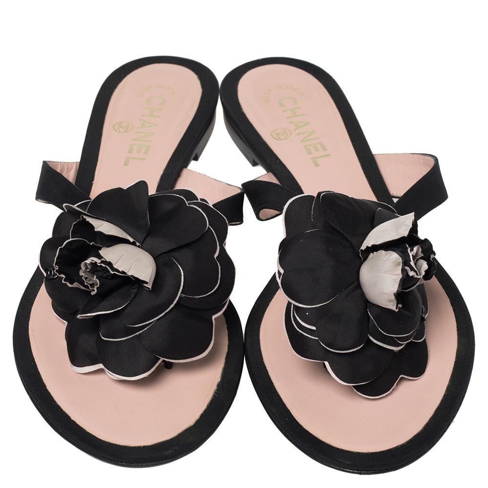 This season, give the Chanel touch to your outfit with these sandals. The pair features a thong design in fabric straps and comfortable leather soles. The pair is complete with a Camellia flower on the uppers.

Includes: Original Box
