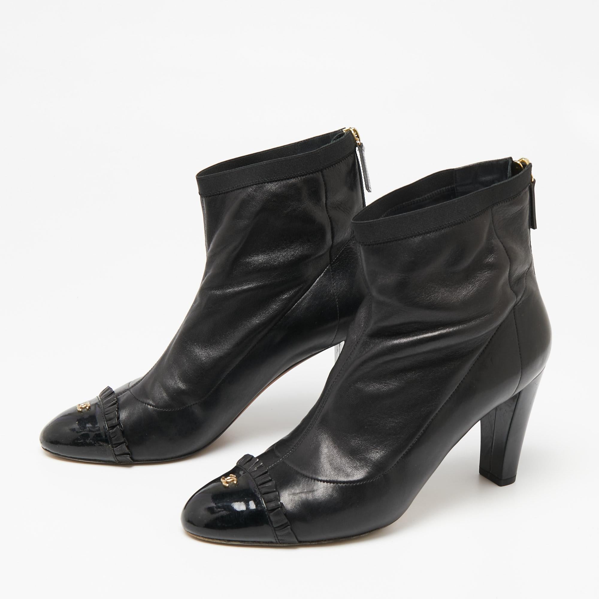 No fashion quest is complete without a pair of boots like these black ones from Chanel. They are crafted from leather and feature patent leather cap toes with the CC logos. The ankle boots are complete with smooth insoles and 9 cm heels to lift you