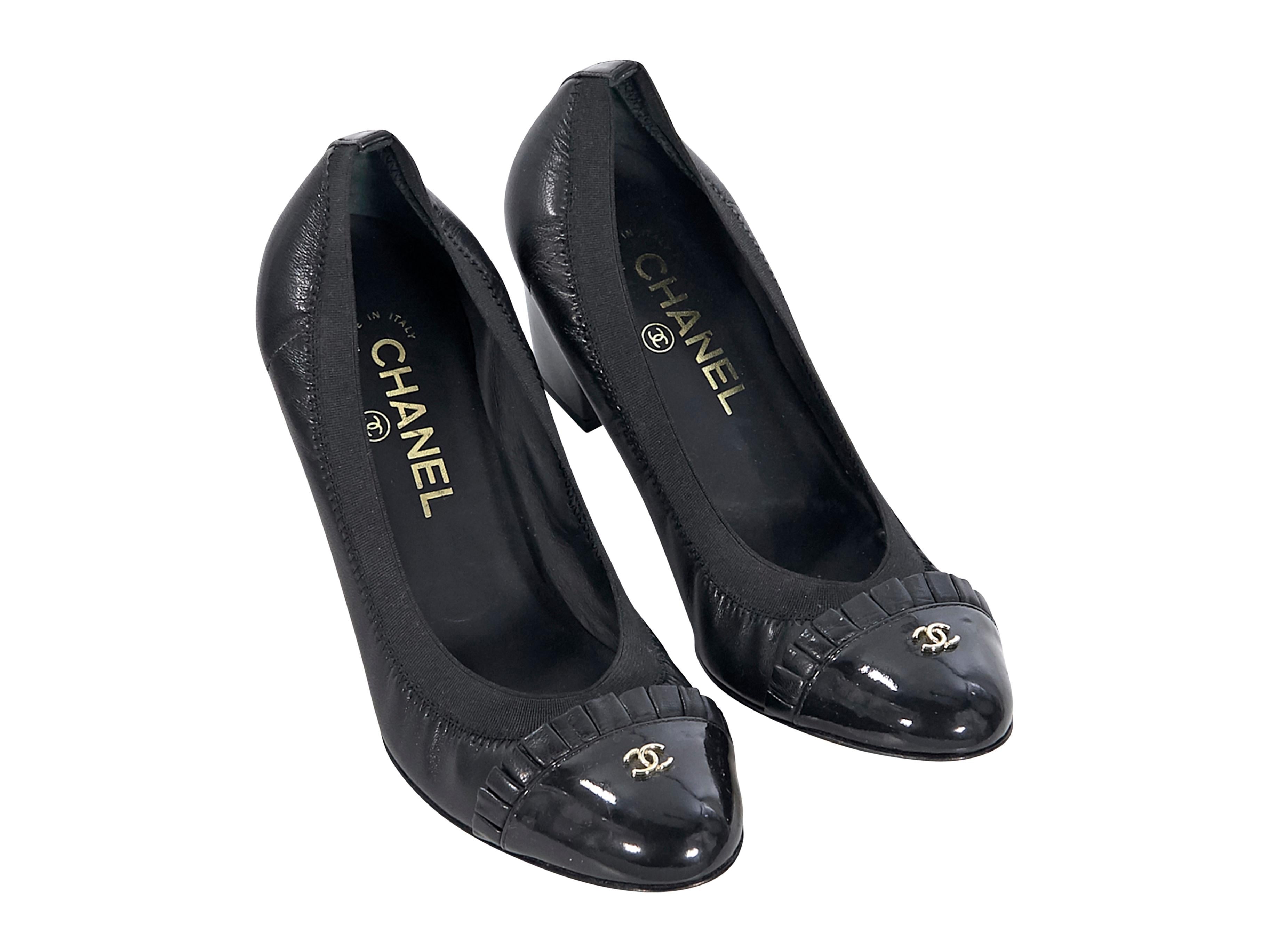 Product details:  Black leather kitten heels by Chanel.  Stretch-fit top line for a comfy fit.  Ruffled patent leather cap toe.  Slip-on style.  
Condition: Pre-owned. Very good.
Est. Retail $ 925.00