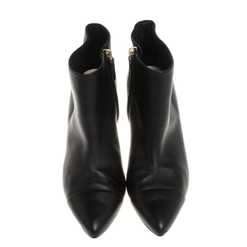 Never go out of style with this classy pair of boots from the house of Chanel. These ankle boots are perfectly crafted from fine and supreme quality leather and designed with CC logo and pearl embellished heels as well as pointed cap toes. Stay
