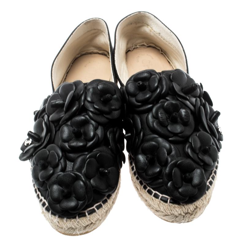 Radiate your fashionable self even in your casuals by owning these espadrilles from Chanel. They've been crafted from leather in black while being styled with the signature Camellia flowers all over the vamps and braided details on the midsole. The