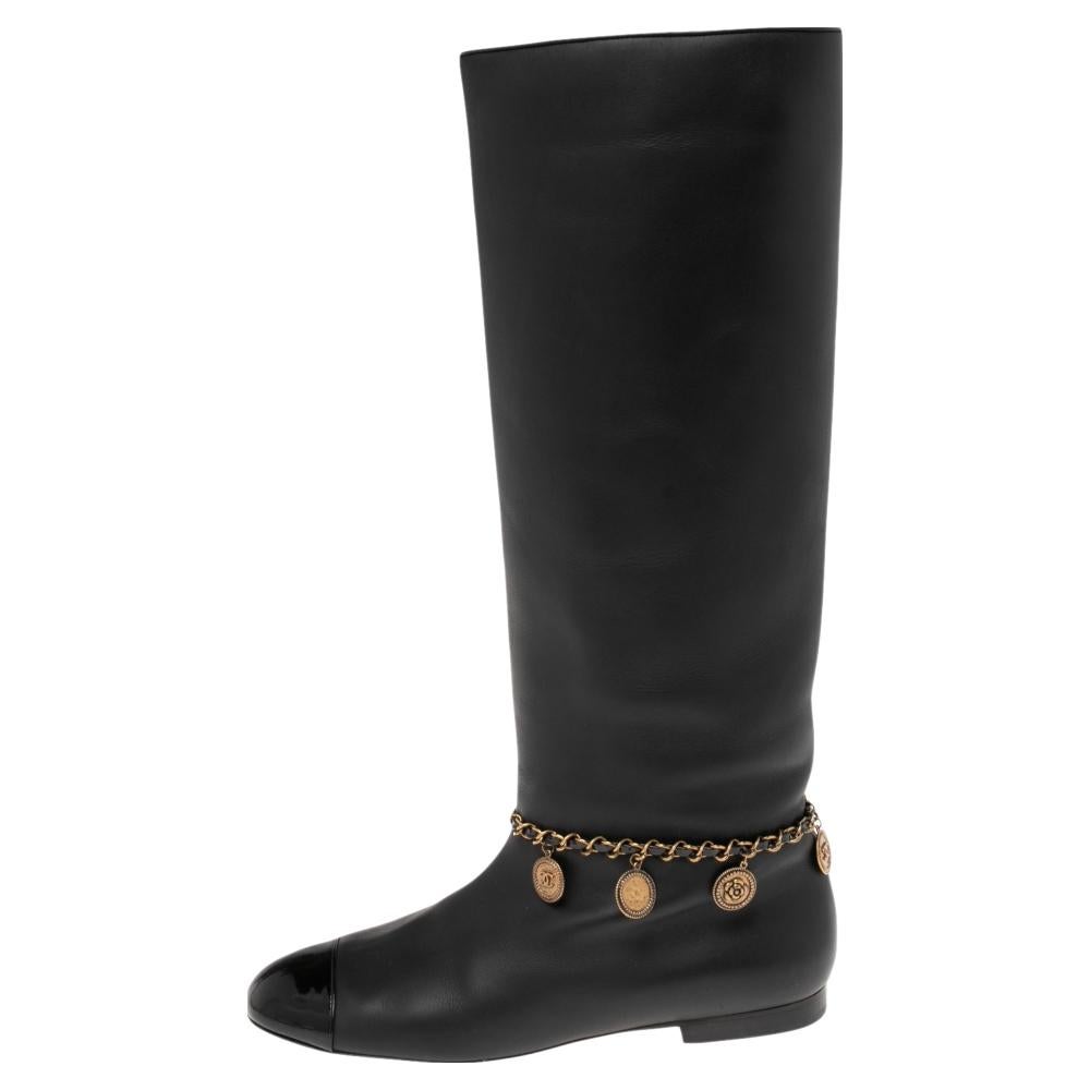 Black boots are closet staples and nothing better than Chanel! They are crafted from leather and detailed with CC chain embellishments around the ankles. The round-toe silhouette comes in a knee-length style.

Includes: Original Box, Original
