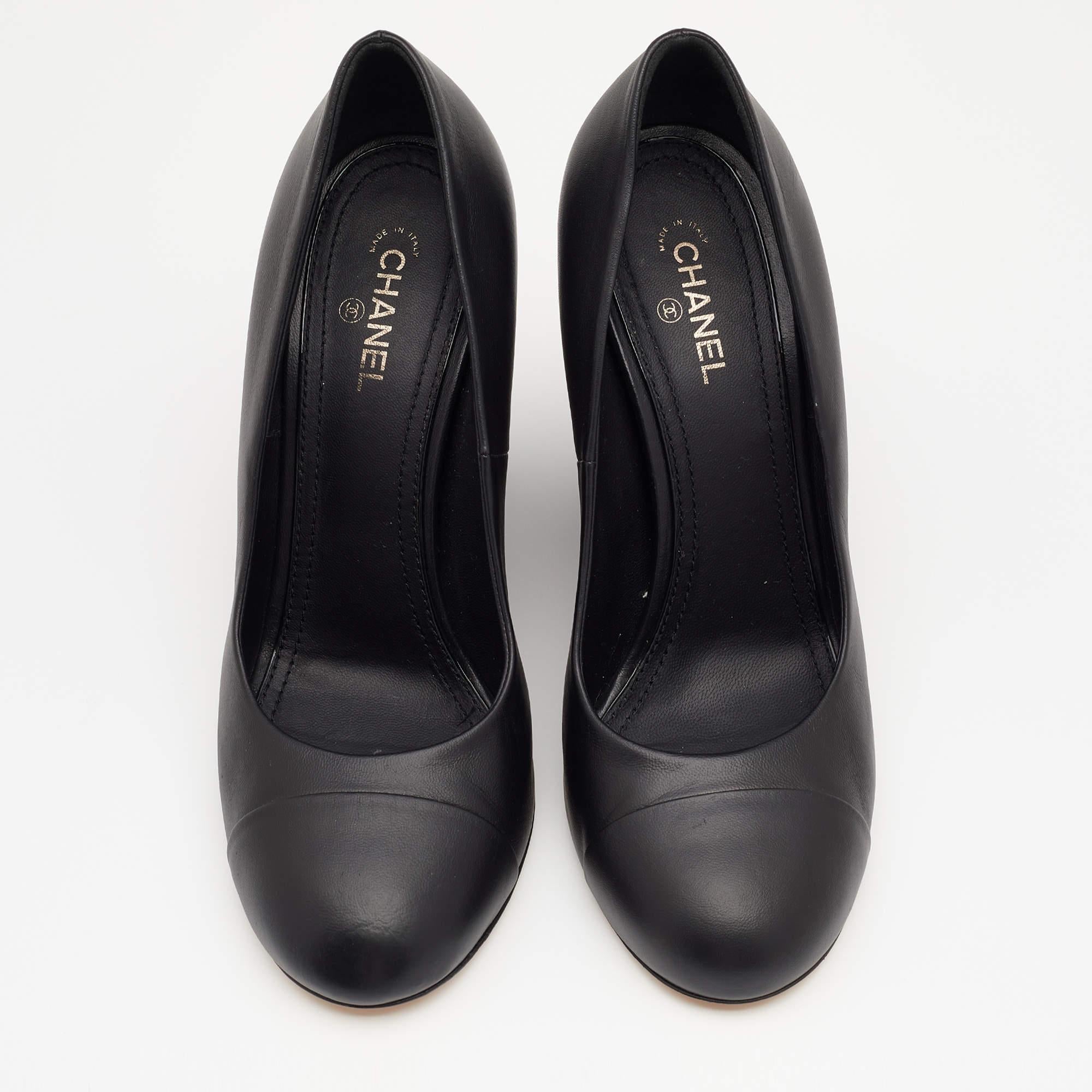 Walk stylishly in these classy pumps from the House of Chanel. Designed using black leather on the exterior, these pumps display wedge heels and rounded cap toes. They are finished with a slip-on style for ease. Match them with your formal dresses