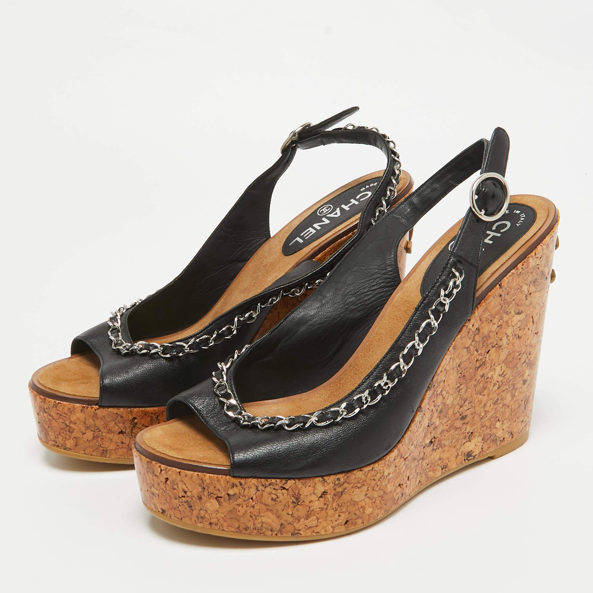 Transform into a style diva when you are wearing these stunning Chanel sandals. Crafted from quality leather  they come in a classic shade of black. They are styled with open toes  signature chain link detailing  CC logo at the back  buckled
