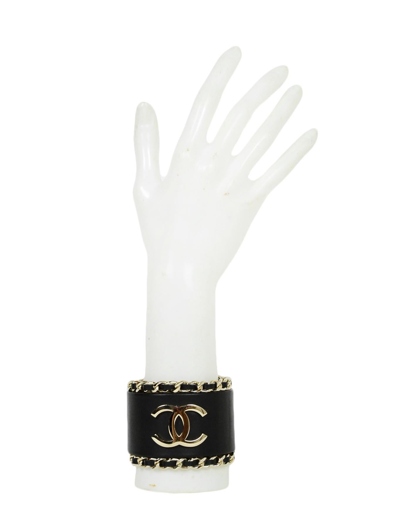 Chanel Black Leather CC Cuff Bracelet w/ Leather Laced Chain Trim
Made In: Italy
Year of Production: 2018
Color: Black, goldtone
Materials: Leather, chain
Hallmarks: B18 CC 8 Made in Italy
Closure/Opening: Bar closure
Overall Condition: Very good