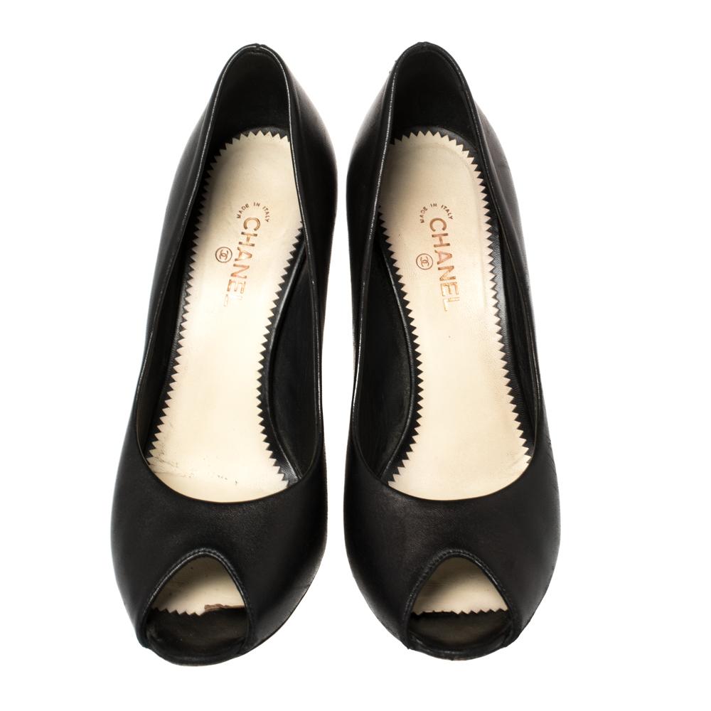 These fabulous pumps from Chanel will lend a luxurious appeal to your looks. They are crafted from leather in black and feature peep-toes. They come equipped with comfortable leather-lined insoles and stand tall on the iconic CC logo detailed 10.5