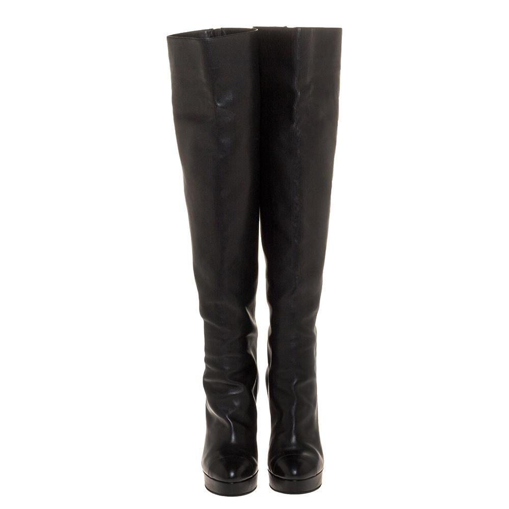 Chanel brings you this fabulous pair of knee-high boots that will give you confidence and loads of style. They've been crafted from leather in a classy black shade and styled in a sharp silhouette with round cap toes, full zippers at the counters,
