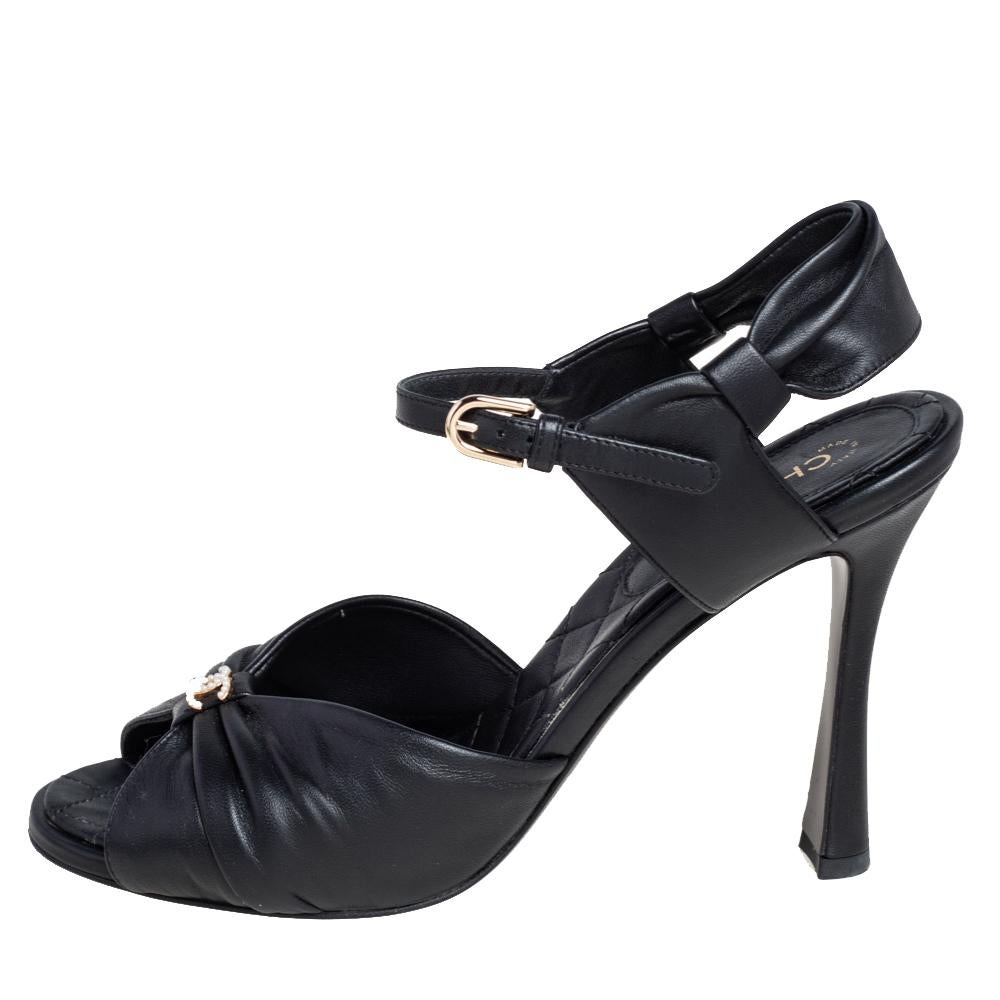A fashionable shoe that is bound to look great with mini, midi as well as maxi hemlines. The sandals by Chanel are crafted from black leather and designed with open toes, the CC logo on the uppers, buckle ankle straps, and 10 cm heels.

Includes: