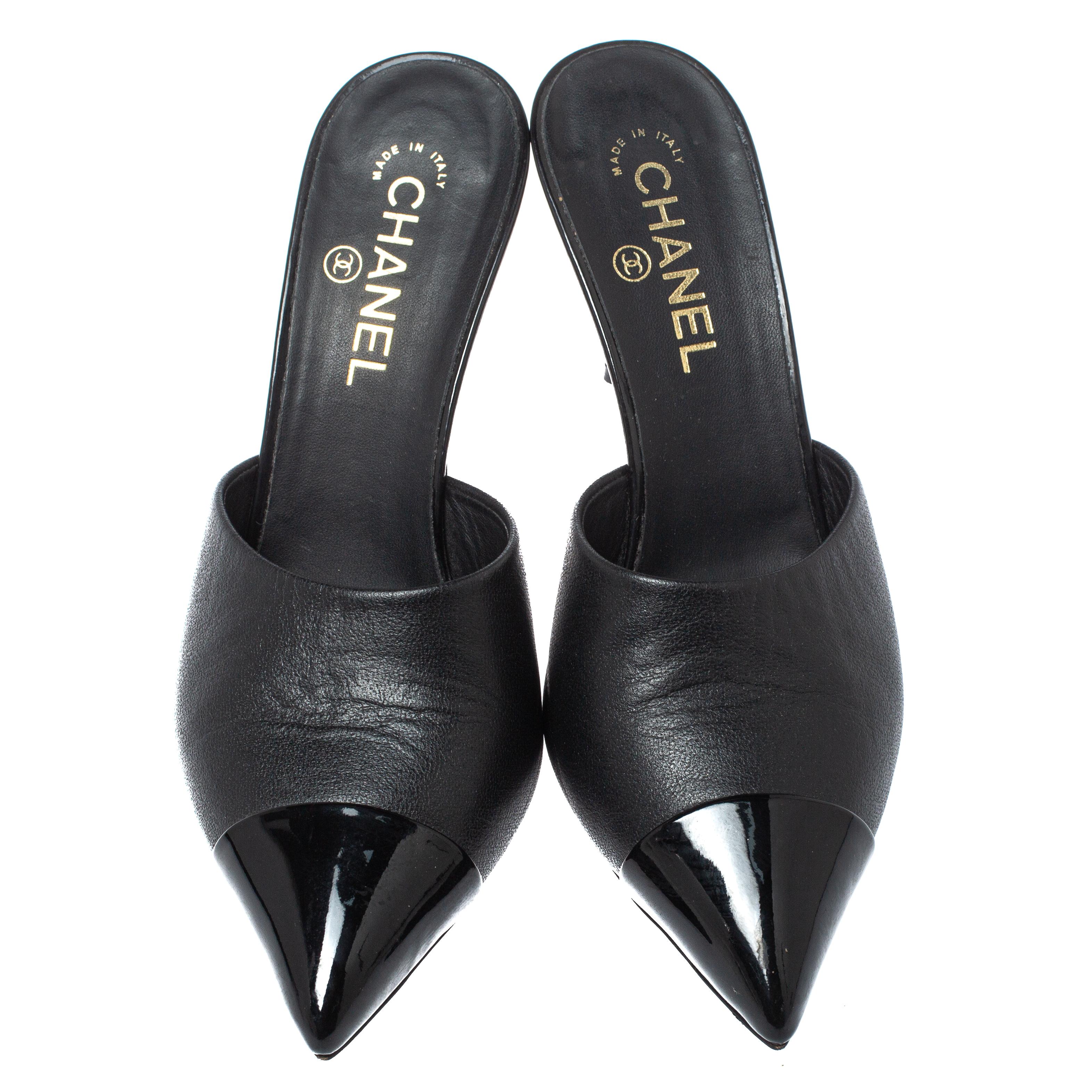 How can one not be smitten by these stunning mules by Chanel! In a magical blend of luxury and high-fashion, the mules come crafted from black leather and designed with patent leather pointed toes and the CC faux pearls on the heels add the perfect