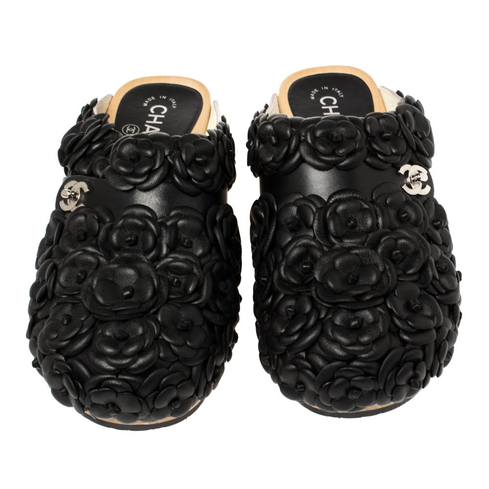 Create your own style statement with these impressive shoes from the house of Chanel. These leather mules are adorned with the signature Camellia flowers all over along with the iconic turnlock motif at the vamps. The rubber soles add comfort to