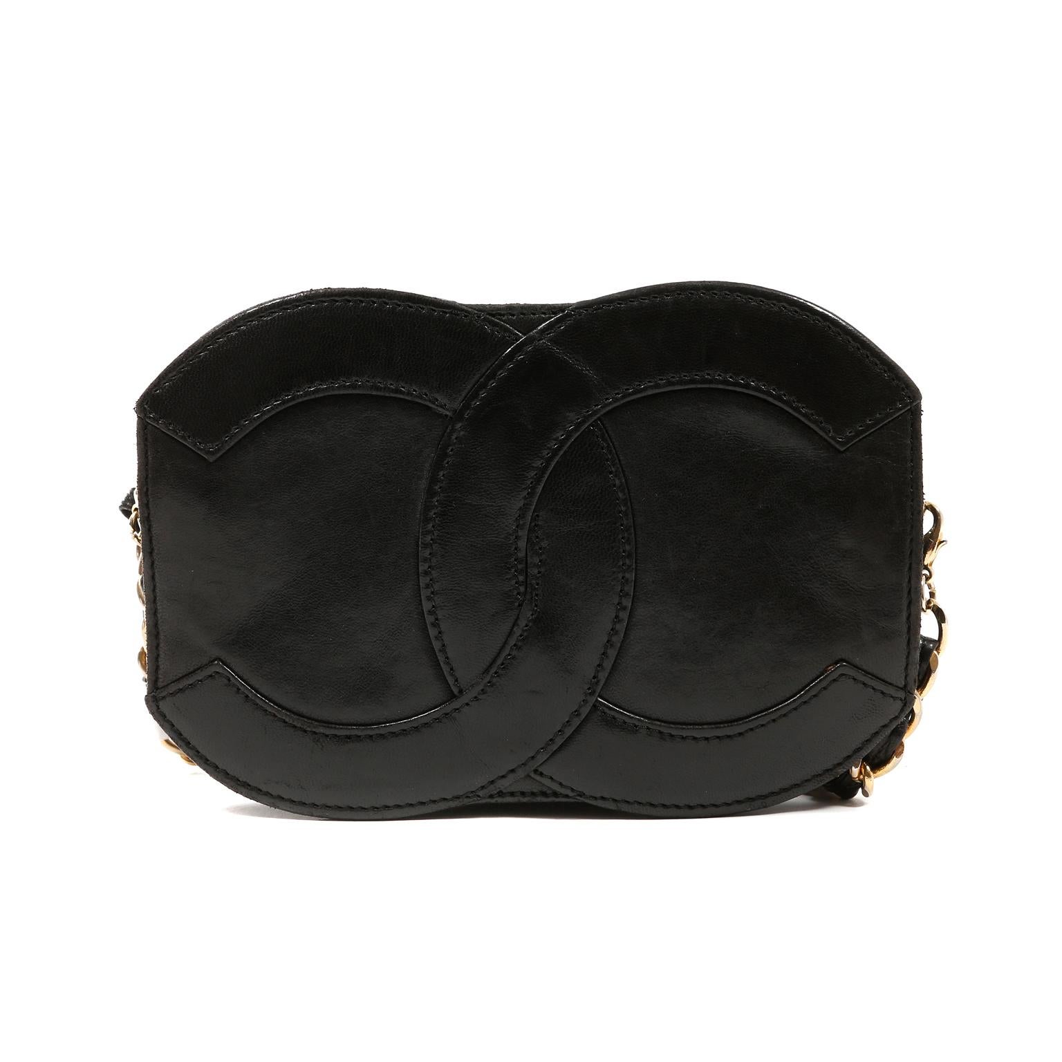 This authentic Chanel Black Leather CC Vintage Crossbody Bag is in very good condition.  It is a highly collectible vintage piece that has enjoyed a previous life.  
Small black leather crossbody is shaped in interlocking CC silhouette.  Zippered