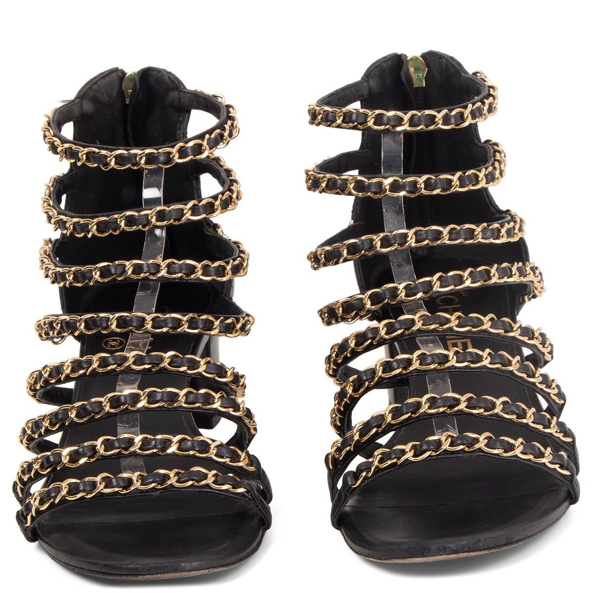 100% authentic Chanel block-heel sandals in black quilted lambskin embellished with gold-tone metal chains. Open with a zipper at the heel. Have been worn and show signs of wear to the tip and a very worn sole. Overall in very good condition.