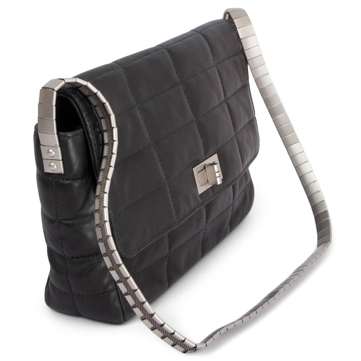 100% authentic Chanel Chocolate Bar Flap shoulder bag in black smooth lambskin featuring silver-tone turn-lock and metal shoulder strap. Lined in black grosgrain with one zipper pocket against the back. Has been carried and is in excellent