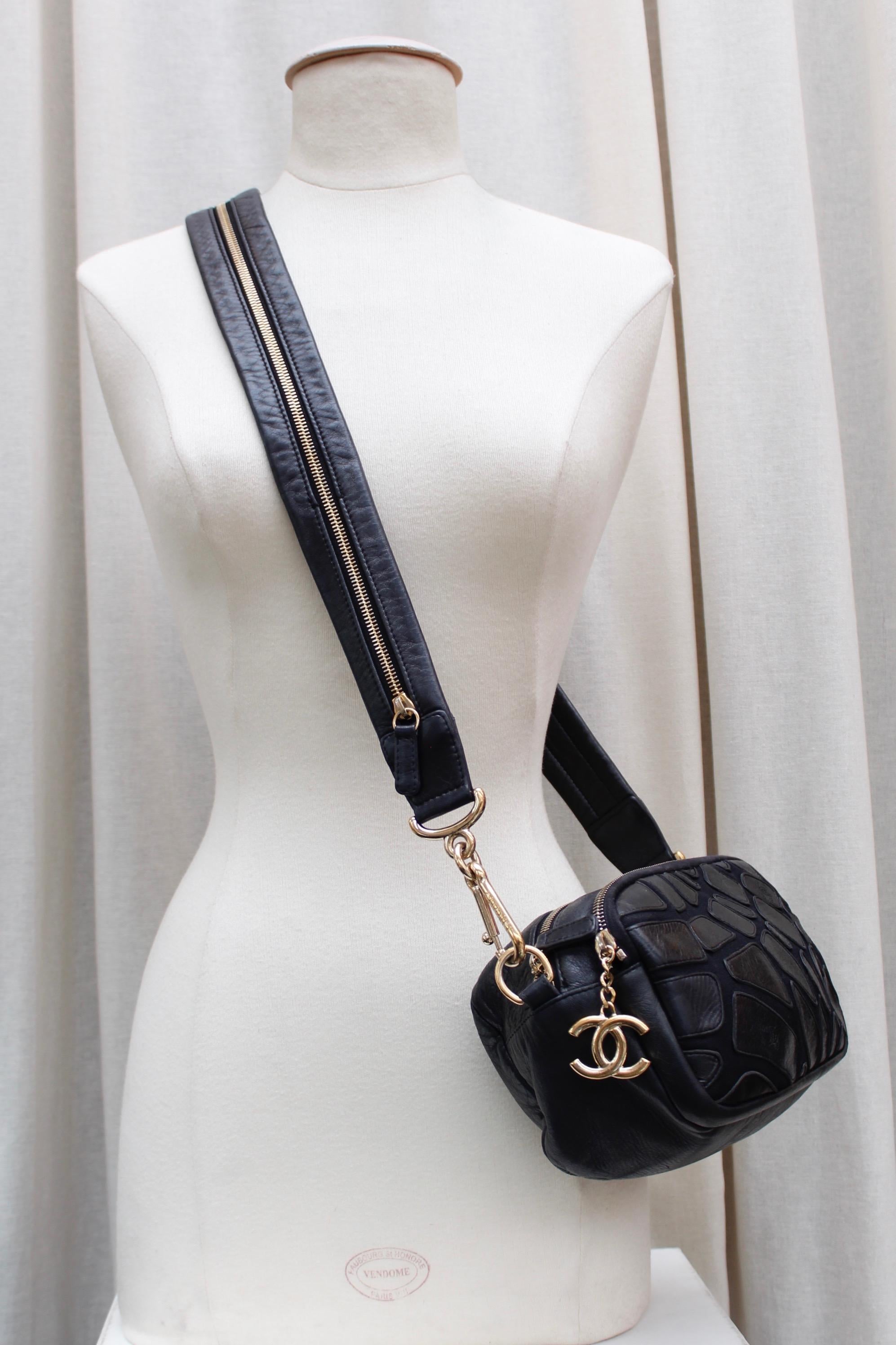 CHANEL (Made in Italy) Small cross-body bag composed of canvas and veal skin. Both faces are decorated with black leather yokes of irregular shape, designed to simulate a wild animal coat. It can be worn cross-body on over the shoulder thanks to its