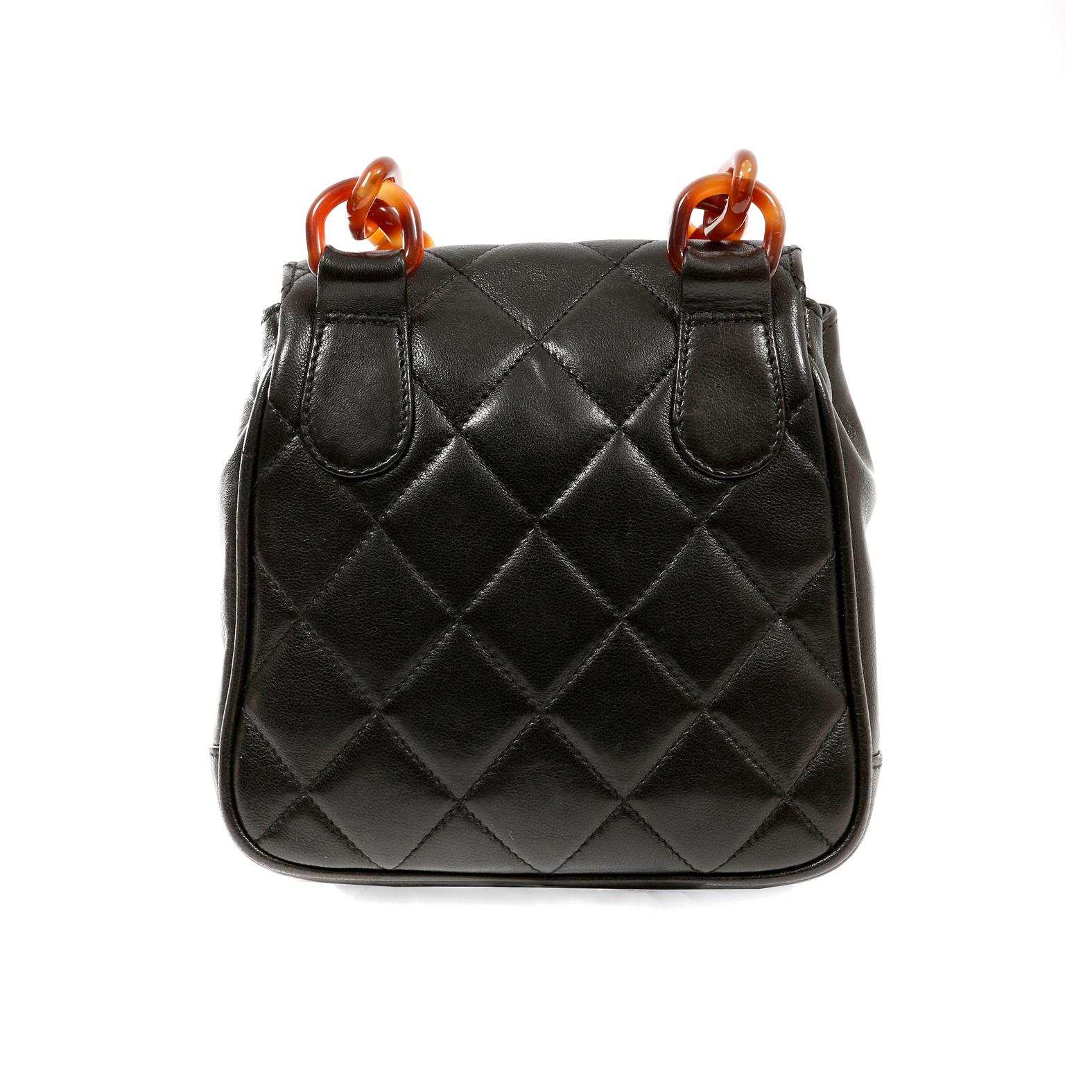 This authentic Chanel Black Leather Tortoise Chain Crossbody Bag is in beautiful vintage condition.  It has enjoyed a previous life and may have some small imperfections. The resin tortoise details makes this a highly collectible piece. 
Black