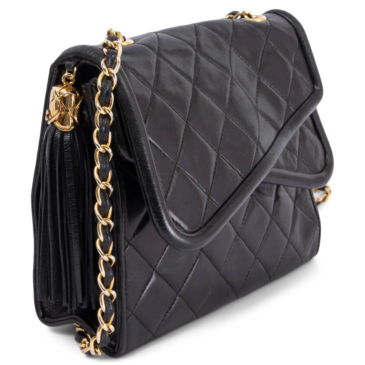 100% authentic Chanel Vintage crossover flap tassel shoulder bag in black quilted smooth lambskin and gold-tone hardware. Opens with a push-button to the main compartment and the front pocket. The interior is lined in calfskin with one zip pocket