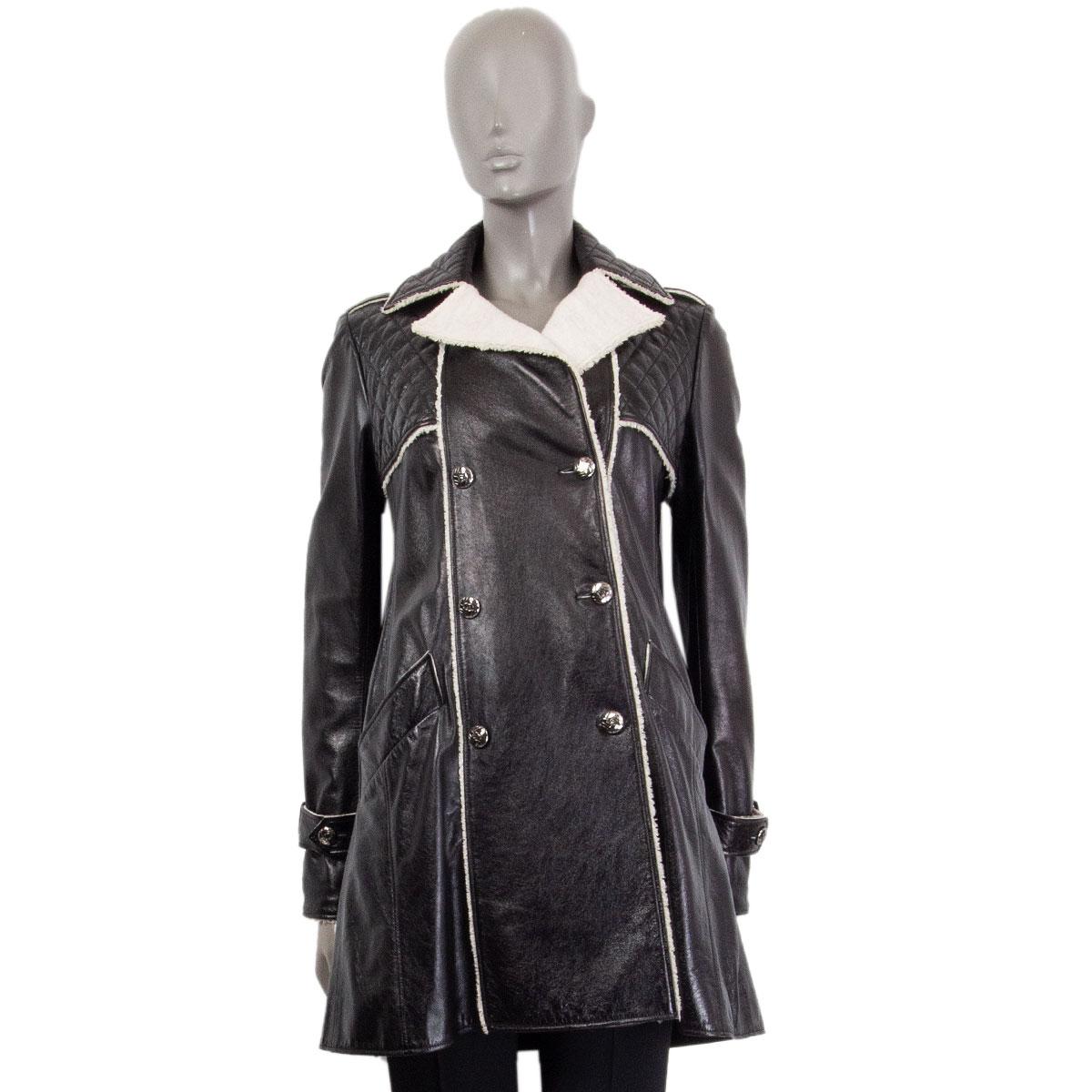 100% authentic Chanel double breasted coat from Metiers d'Art 2011 in black lambskin (100%). With a detailed fringed hemline, stitched notch collar, slight A-line and cuffs straps. Lined in black silk (100%) and wool (100%). Closes in the front with