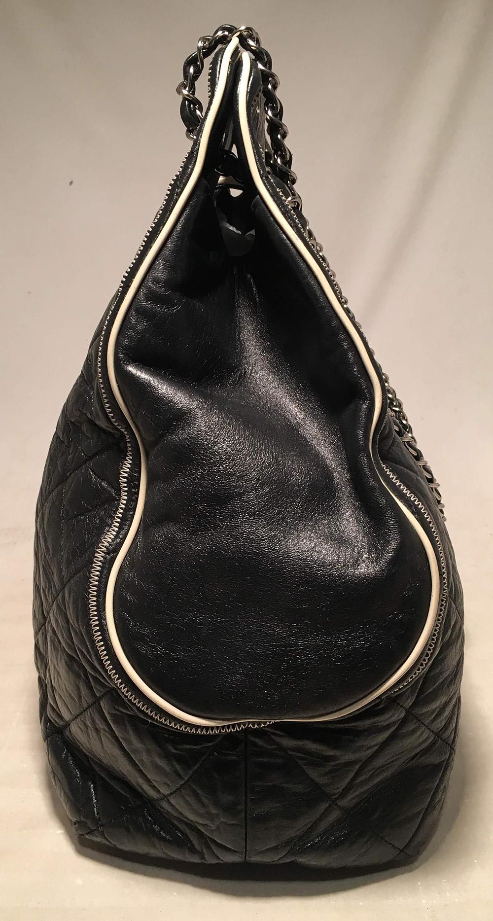 Chanel Black East West Mademoiselle Cut Out Handle Tote in excellent condition. Quilted black leather exterior trimmed with cream leather piping, silver hardware, and signature woven chain and leather shoulder strap. Large mademoiselle style twist