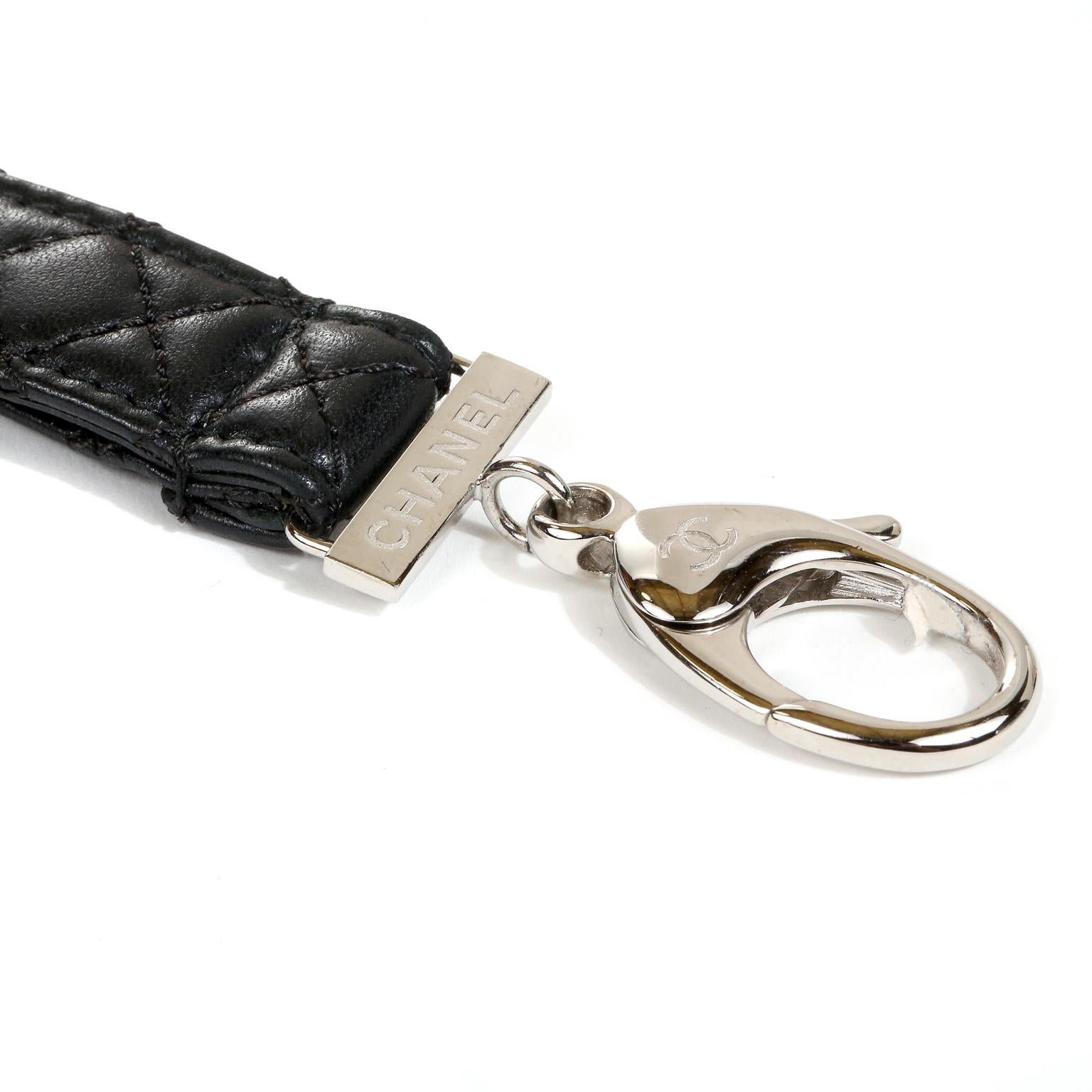 This authentic Chanel Black Leather Lanyard is in mint condition.  Black leather is stitched in signature Chanel diamond pattern.  Silver tone lobster claw at the end holds whatever catches your fancy. Approximately 29 inches.   Pouch or box