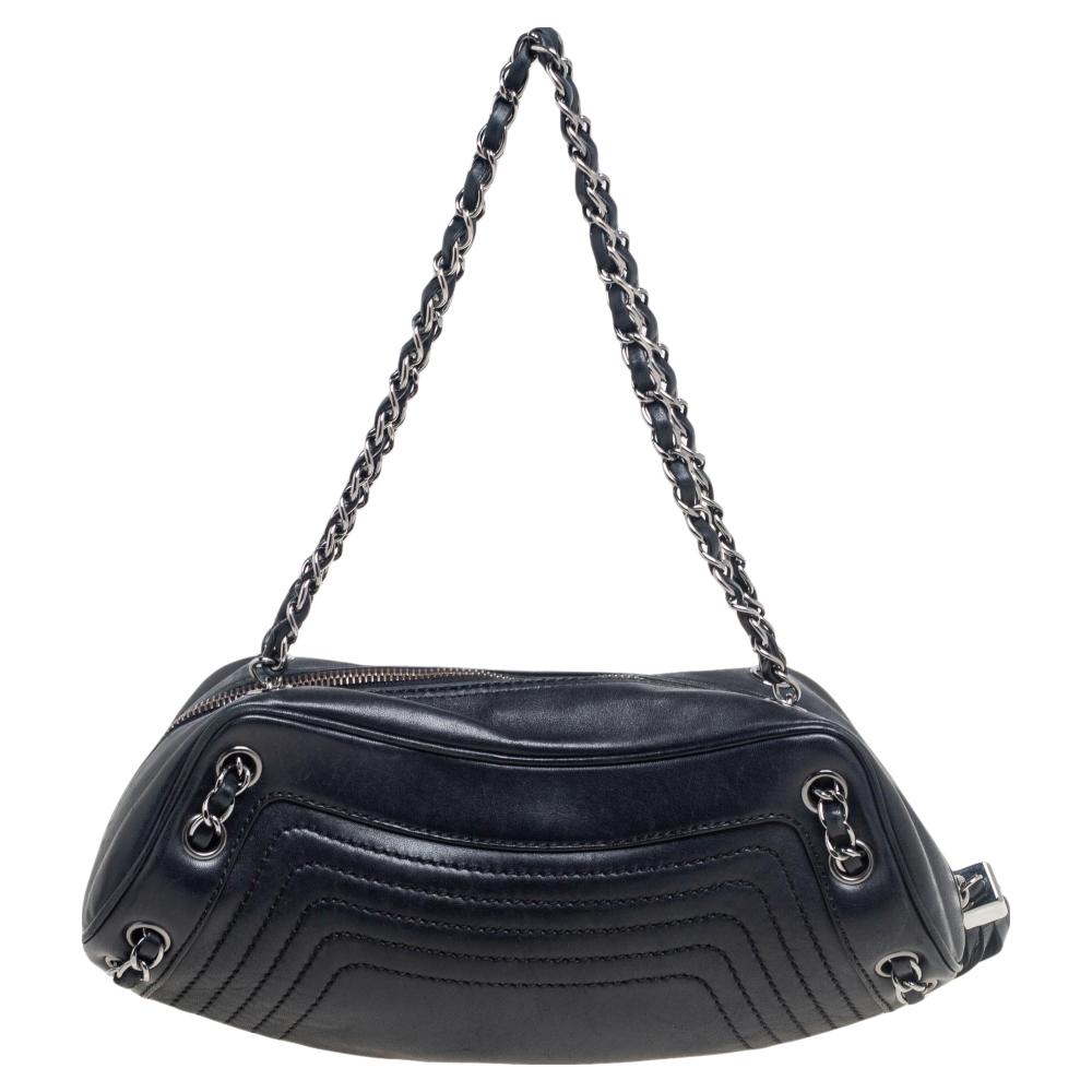 This Chanel LAX bag is an example of the brand's fine designs that are skillfully crafted to project a classic charm. The shoulder bag is made of leather and enhanced with quilting, the brand label on the front, a tassel zipper pull, and woven chain