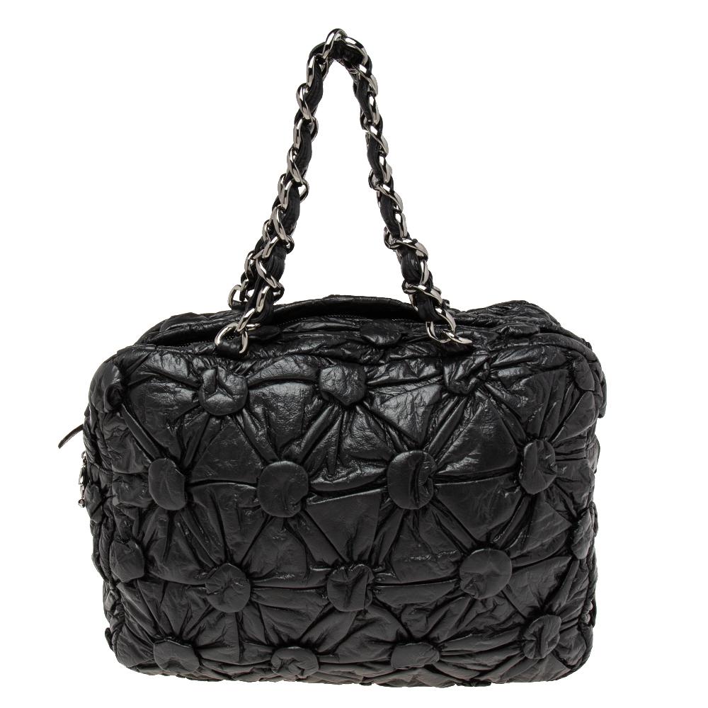 Flawless craftsmanship and timeless design aesthetics combine to make this Chanel Bowler bag perfect from workday to the weekend. It is sewn using black leather and attached with two chain-detailed handles. The spacious interior will dutifully hold