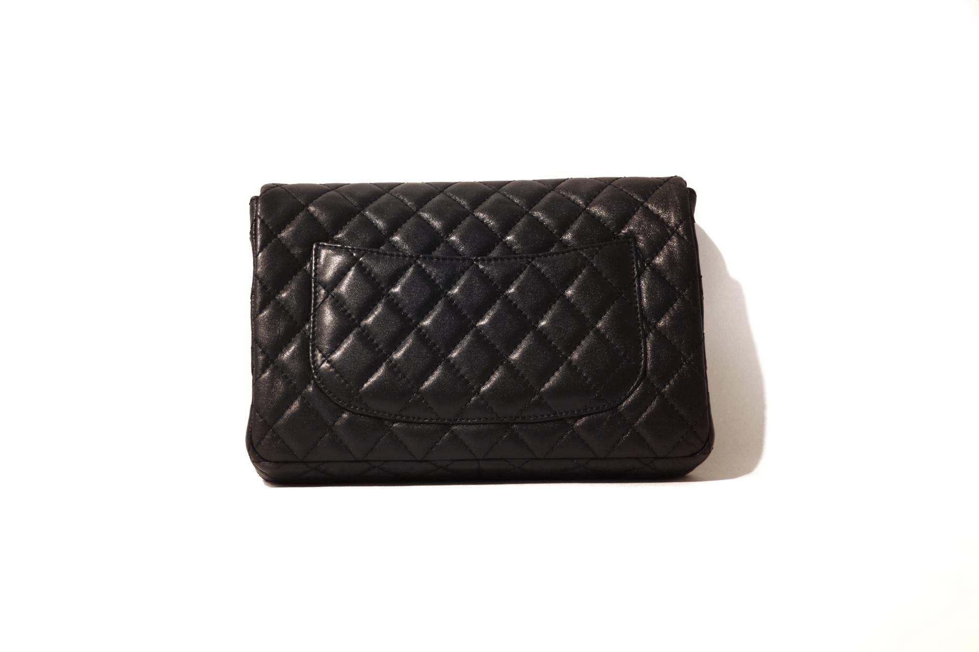 This authentic Chanel Classic Mademoiselle Flap Bag is in excellent condition.  
Black calfskin is quilted in signature Chanel diamond pattern.  Matte gold mademoiselle twist lock closure secures the front flap.  Single snake chioan strap may be
