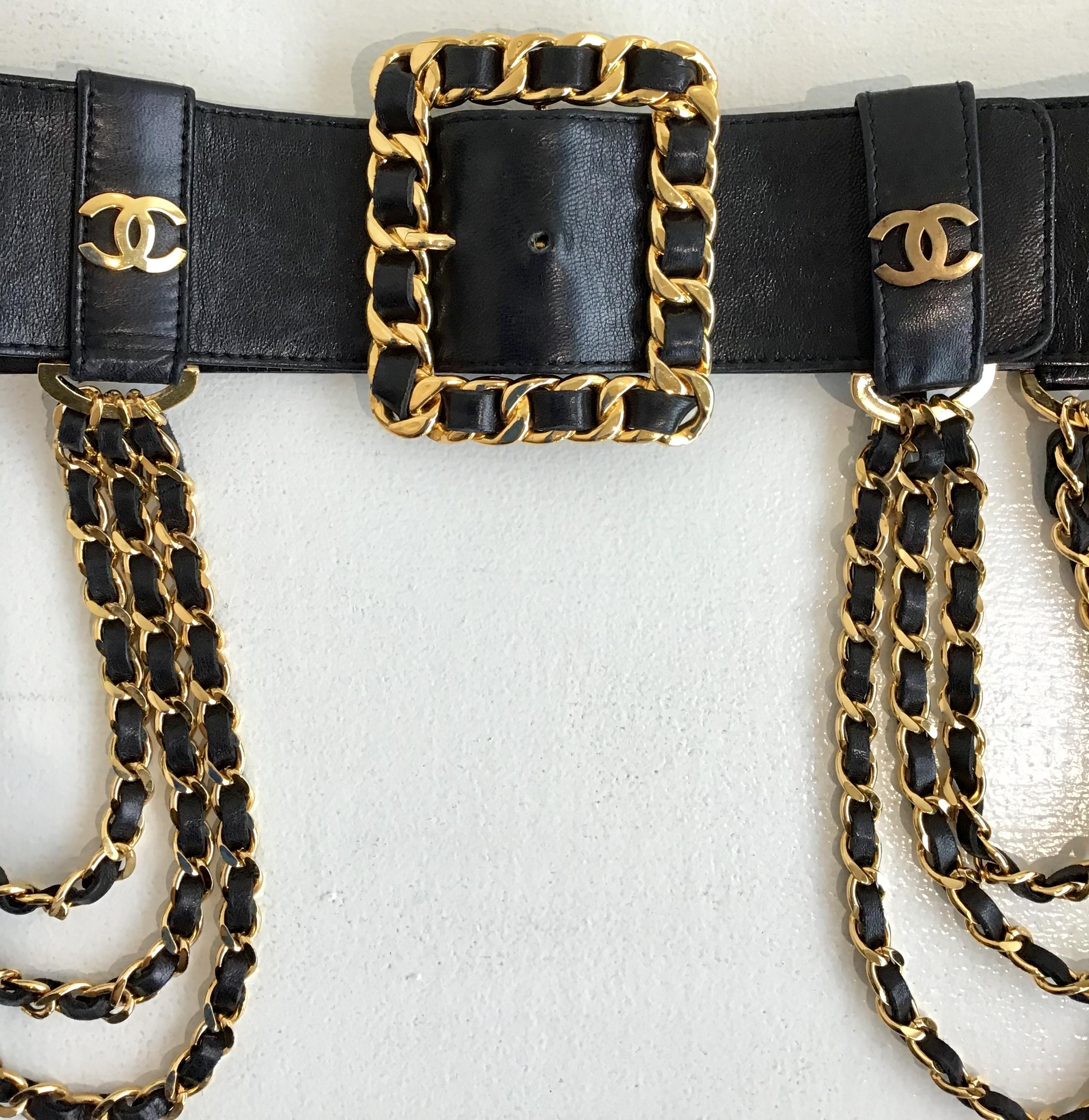 Chanel Black Wide Leather Multi Chain and Logo Belt. Featuring a gold toned chain link buckle at the front, Chanel logo on either side of buckle, including 3 chains on each side draped over the hips. Size 34. 