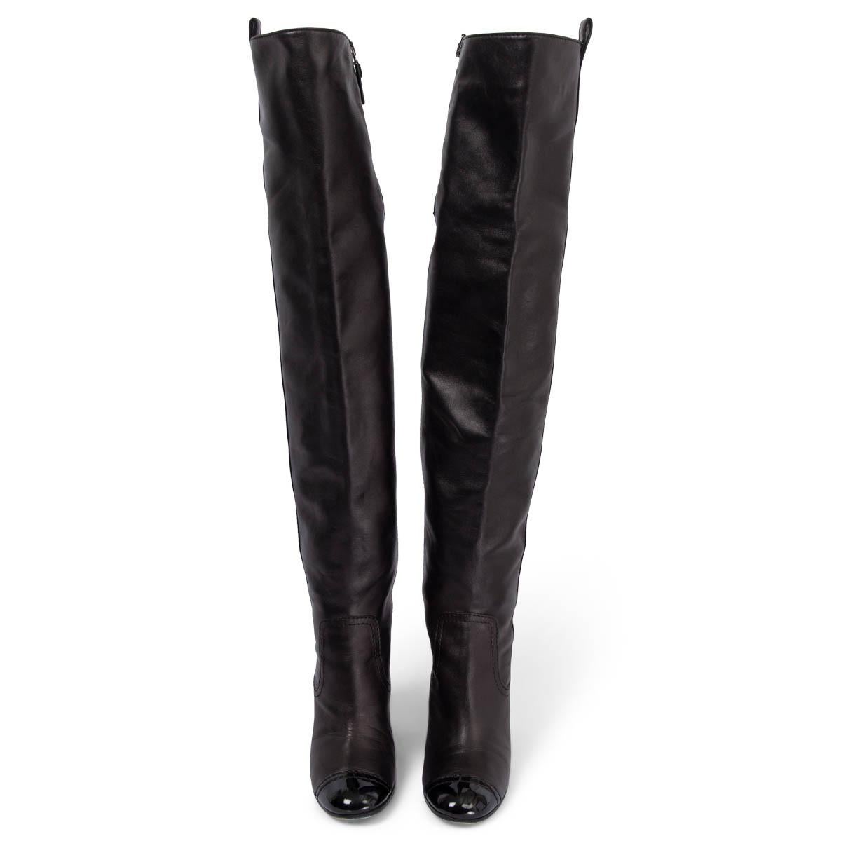 100% authentic Chanel over-knee boots in black smooth lambskin leather with signature patent toe tip. Open with a zipper to a light beige satin lining. Have been worn and show some scuffs along the zipper. Overall in very good condition.