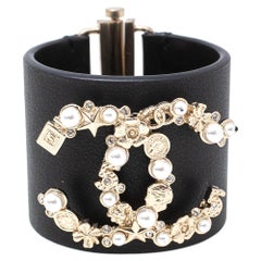 Chanel Black Leather Pale Gold Tone Embellished Logo Cuff Bracelet