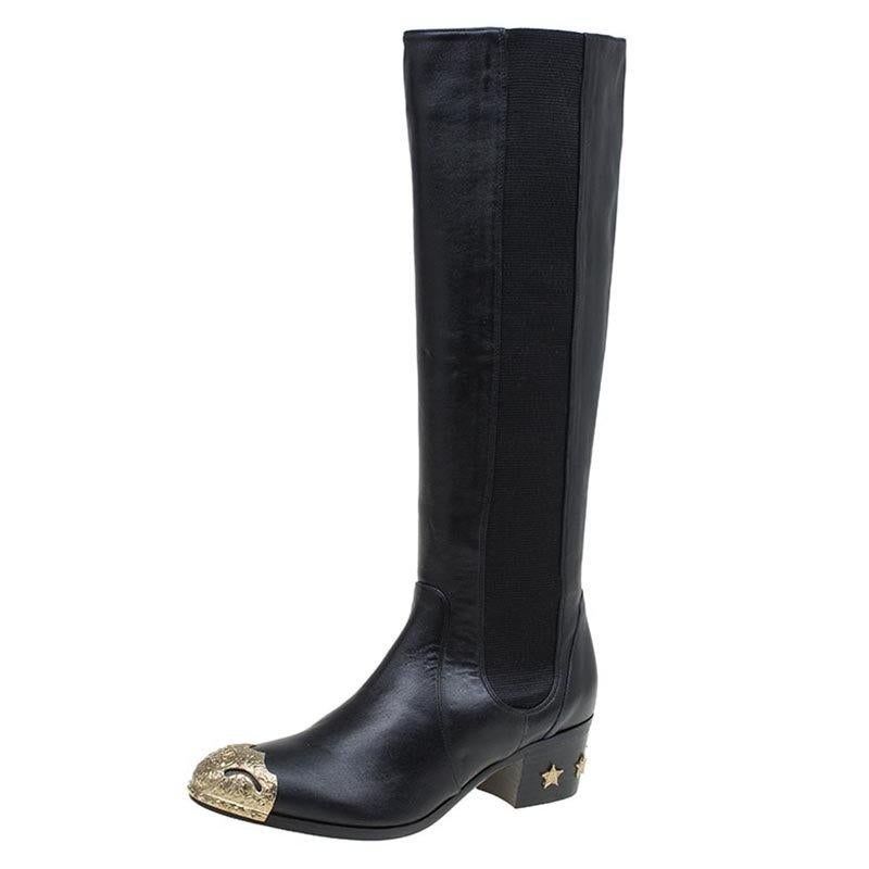 Your winter wardrobe would take an all new shape by adding these stunning knee-length boots by Chanel. These are classic black leather boots with a hint of sparkle added by the gold tone toe cap detail. Adding to the shimmer are the star