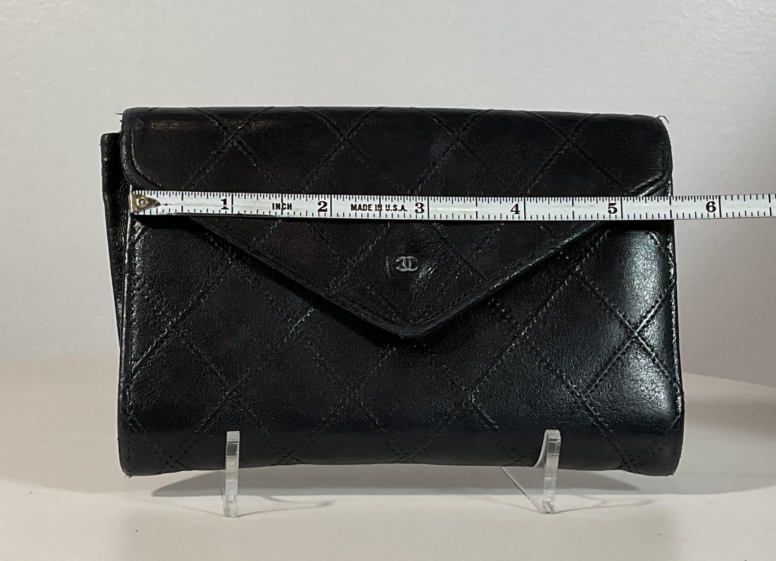 Chanel black quilted leather wallet. This wallet is in 'LIKE NEW' condition. There are no significant flaws or wear areas to consider with this lovely wallet. It had been very gently used and carefully stored in its sleeper bag over the