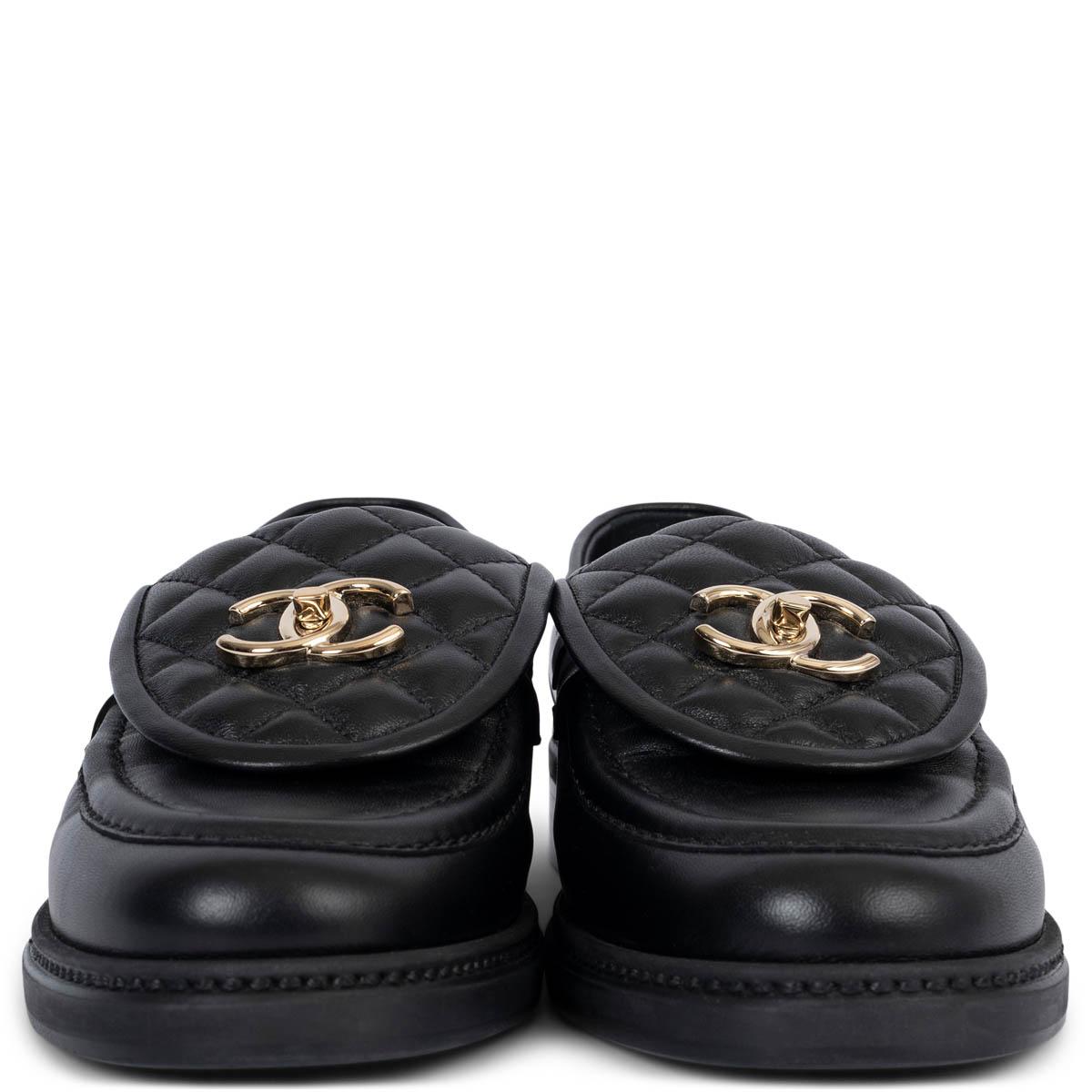 These 100% authentic Chanel REV turnlock loafers are crafted from sleek black smooth leather and feature a signature quilted flap detail. The design is elevated with a beige gold-tone metal CC logo turnlock, adding a refined, iconic touch. Timeless