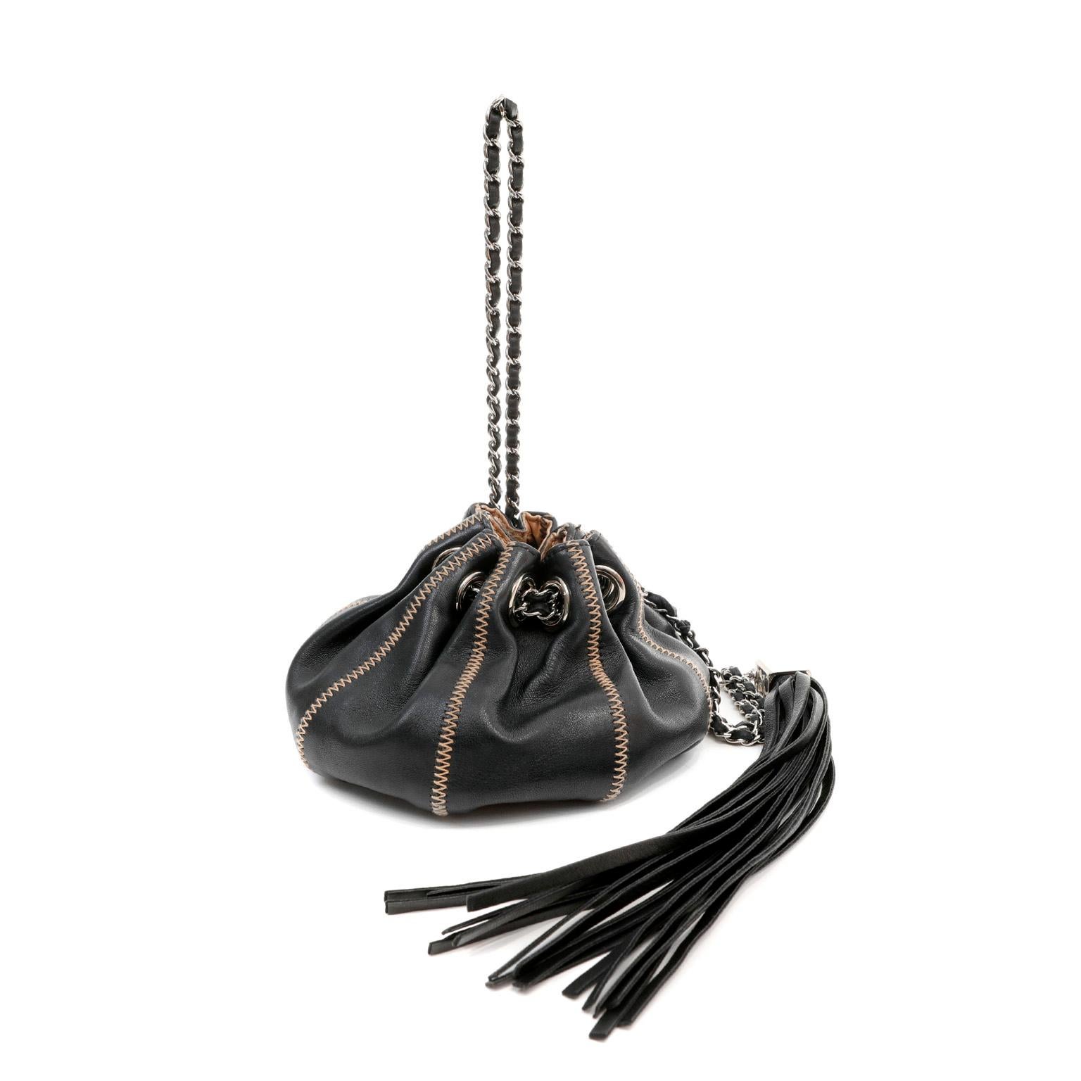 This authentic Chanel Black Leather Reversible Pouchette is in beautiful condition.  A feminine petite bag for evening, this versatile reticule may be reversed to the satin beige side. Black leather drawstring style pouch has contrasting zig zag