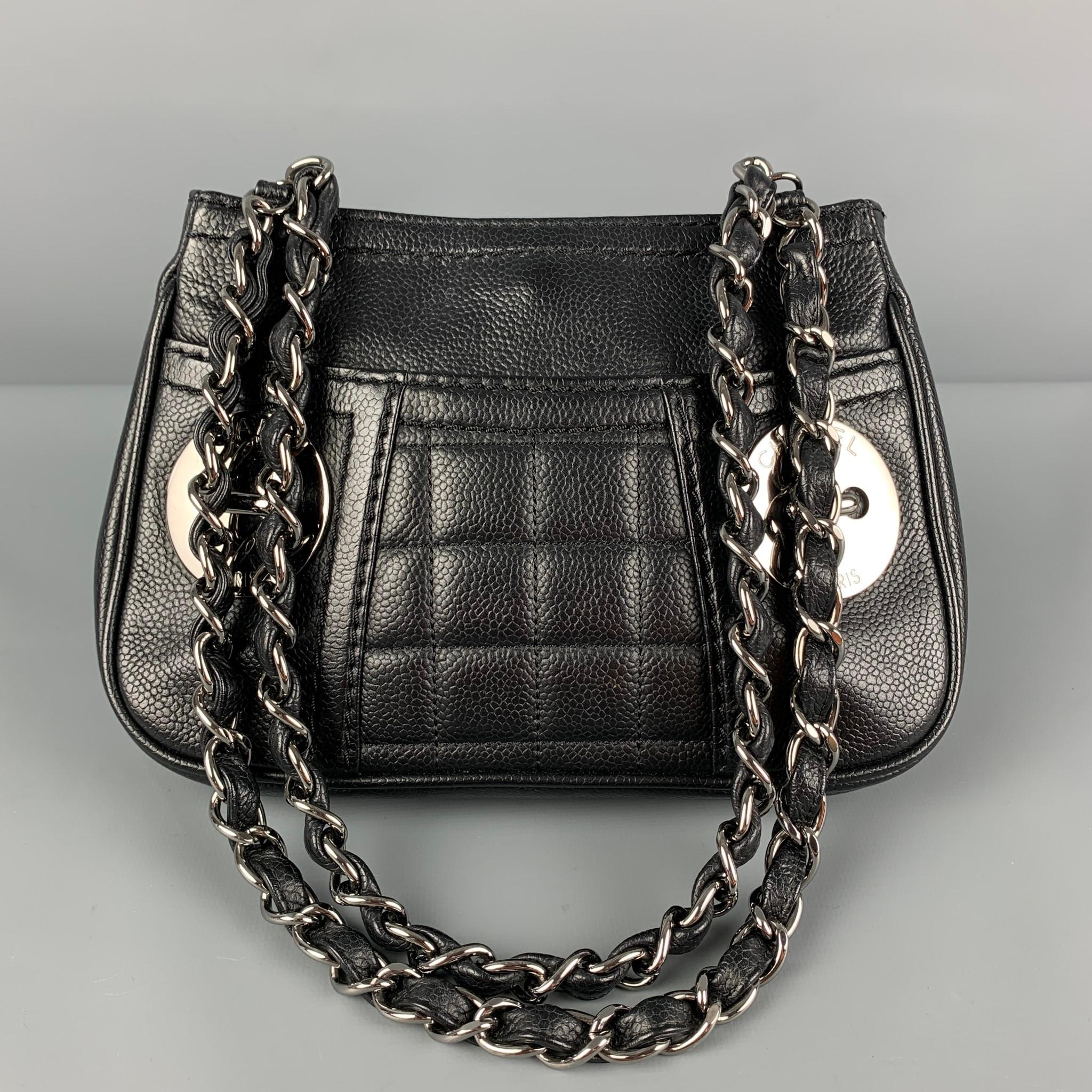 CHANEL handbag comes in a black leather with a red interior featuring signature double chainlink top handles, front silver tone logo details, quilted panel, and a snap button closure. Made in Italy. 

Very Good Pre-Owned Condition.
Marked: