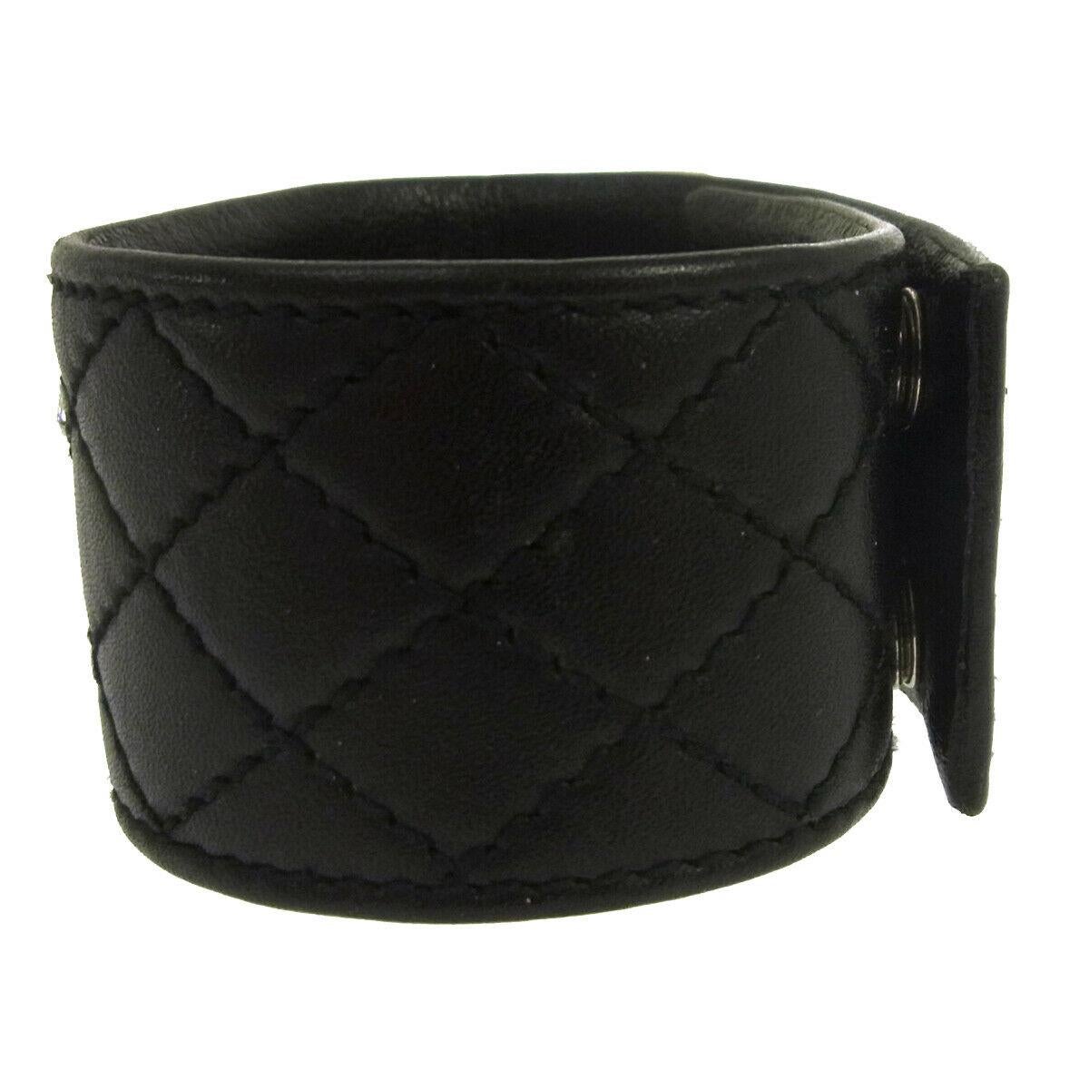 Chanel Black Leather Silver Charm Men's Women's Wide Cuff Bracelet in Box

Leather
Silver tone hardware
Snap closure
Made in France
Width 1.5