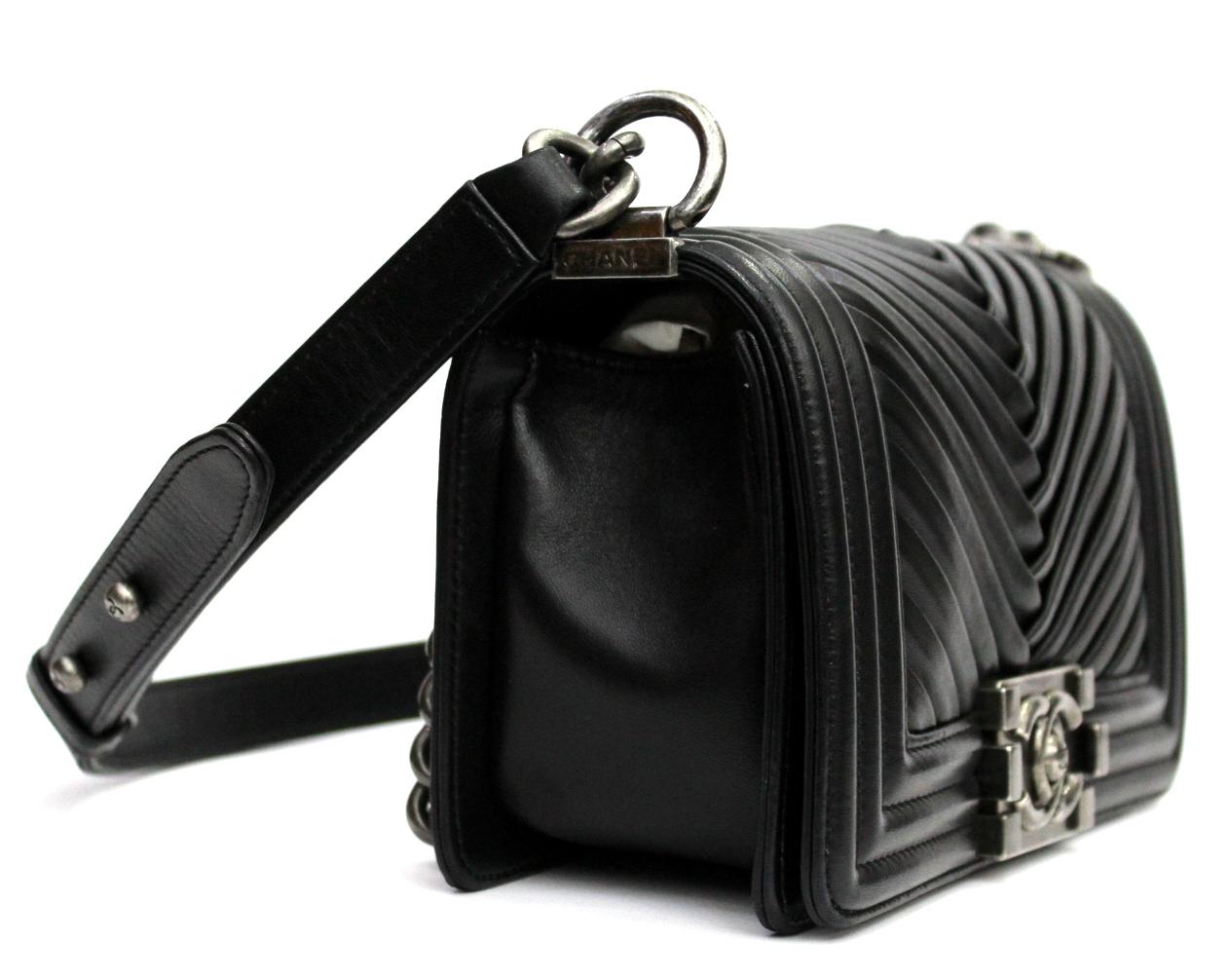 Beautiful Chanel Boy bag made of lambskin with chevron pattern. Black color with hardware silver. This is the smallest measure about 