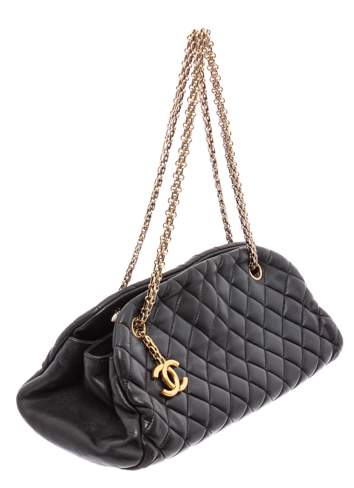 Black quilted leather Chanel Small Just Mademoiselle Bowling bag with antiqued gold-tone hardware, dual chain-link shoulder straps featuring logo charm, burgundy canvas lining, three compartments, single zip pocket at interior wall and open